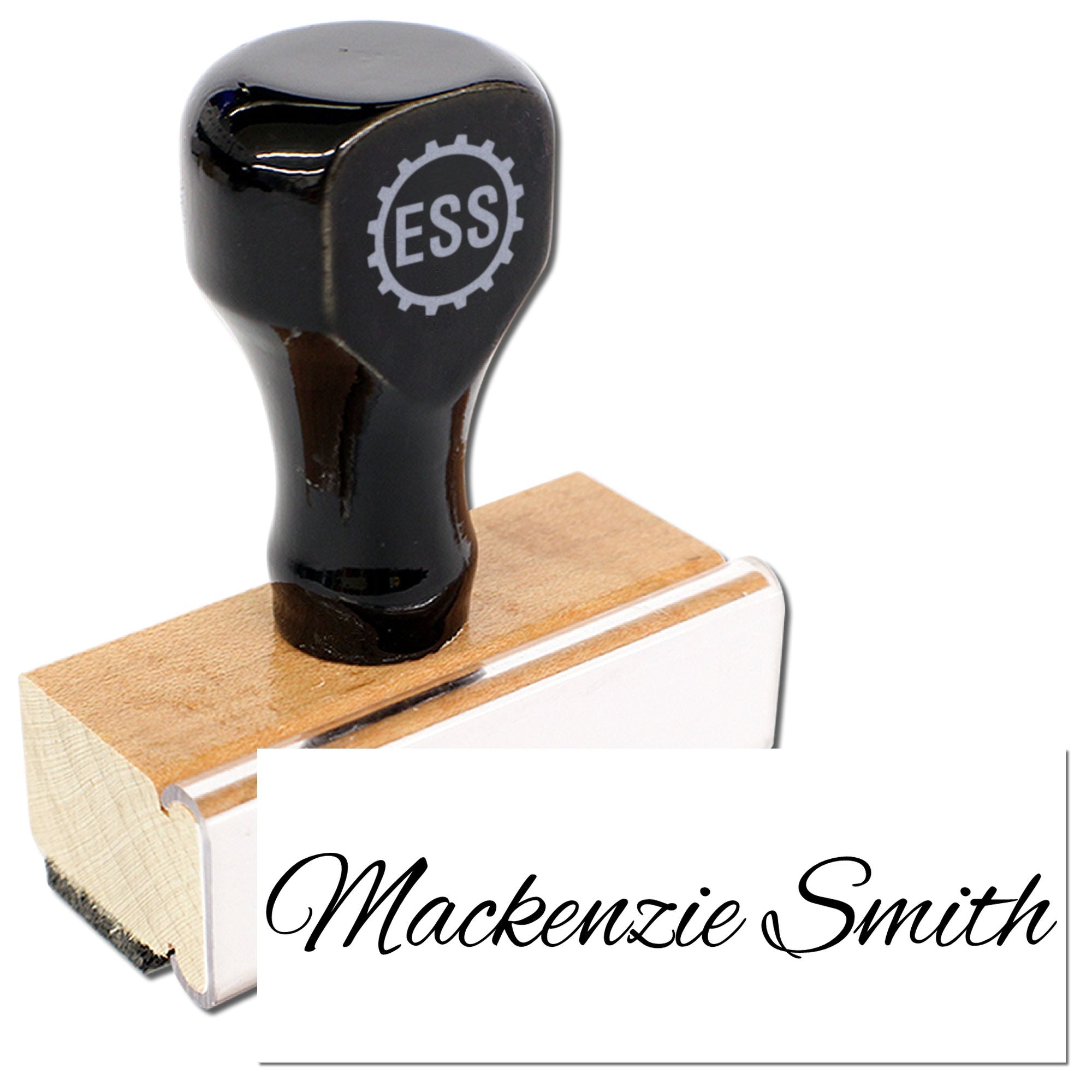 Black custom stamp and seal on wooden block, imprinting a white card with black script Mackenzie Smith.