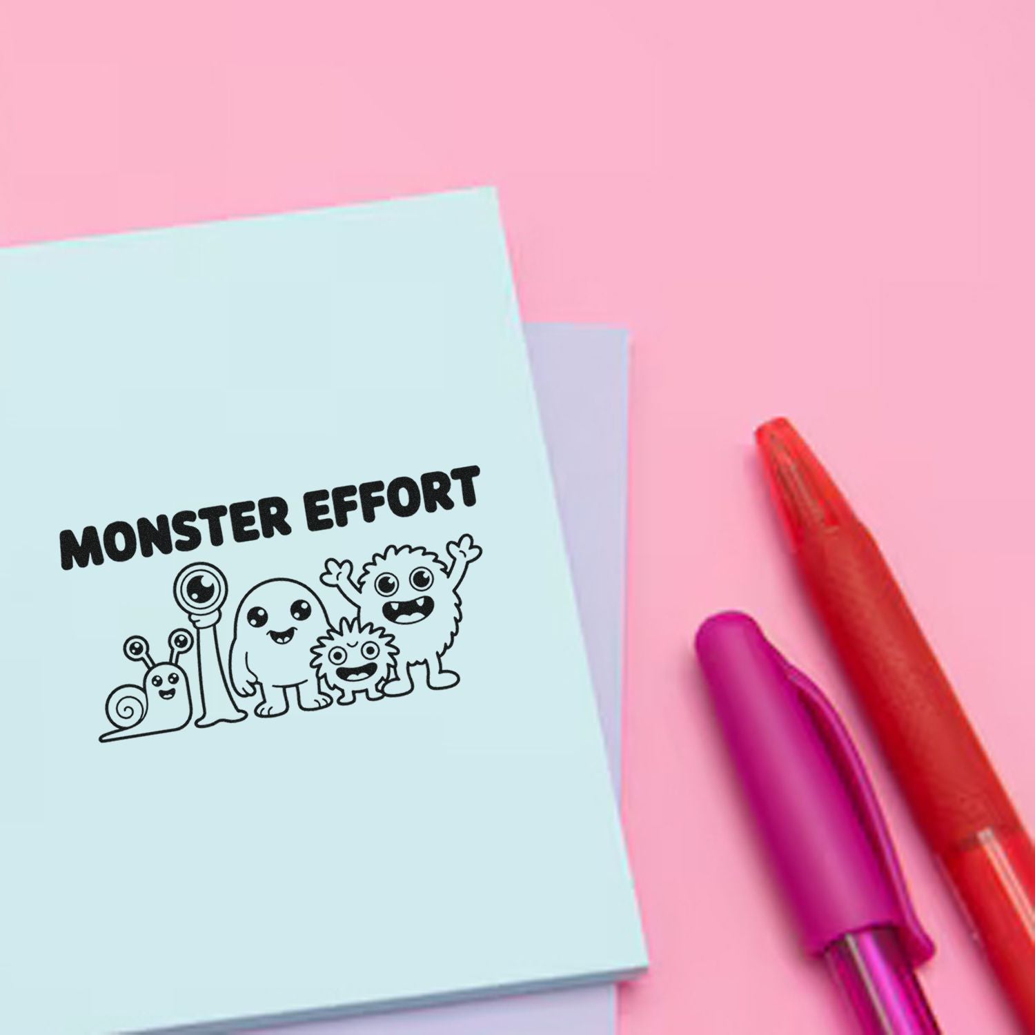 Monster Effort stamp and seal product on pastel blue paper, with cute monster doodles, pink background, red and purple pens
