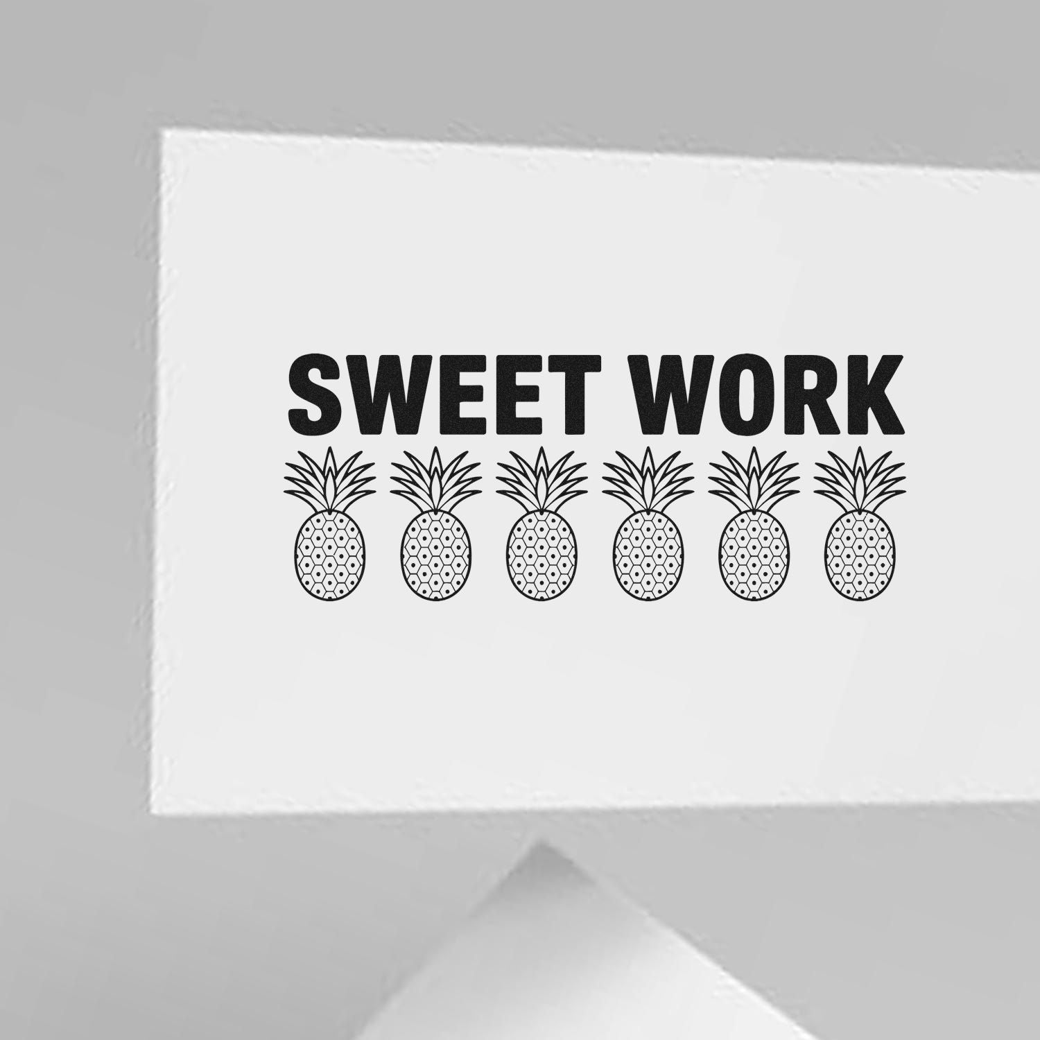 White custom stamp seal with bold black SWEET WORK text and six pineapple icons.