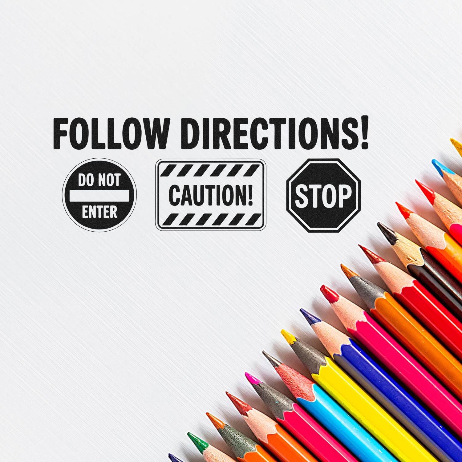 Black FOLLOW DIRECTIONS stamp and seal set with Do Not Enter, Caution, and Stop icons beside colorful pencils.