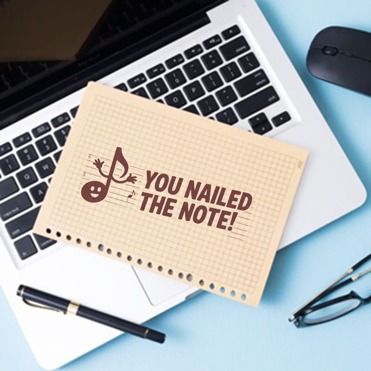 Beige stamp-and-seal note with brown You nailed the note! text on a laptop, beside a black pen, mouse, and glasses.