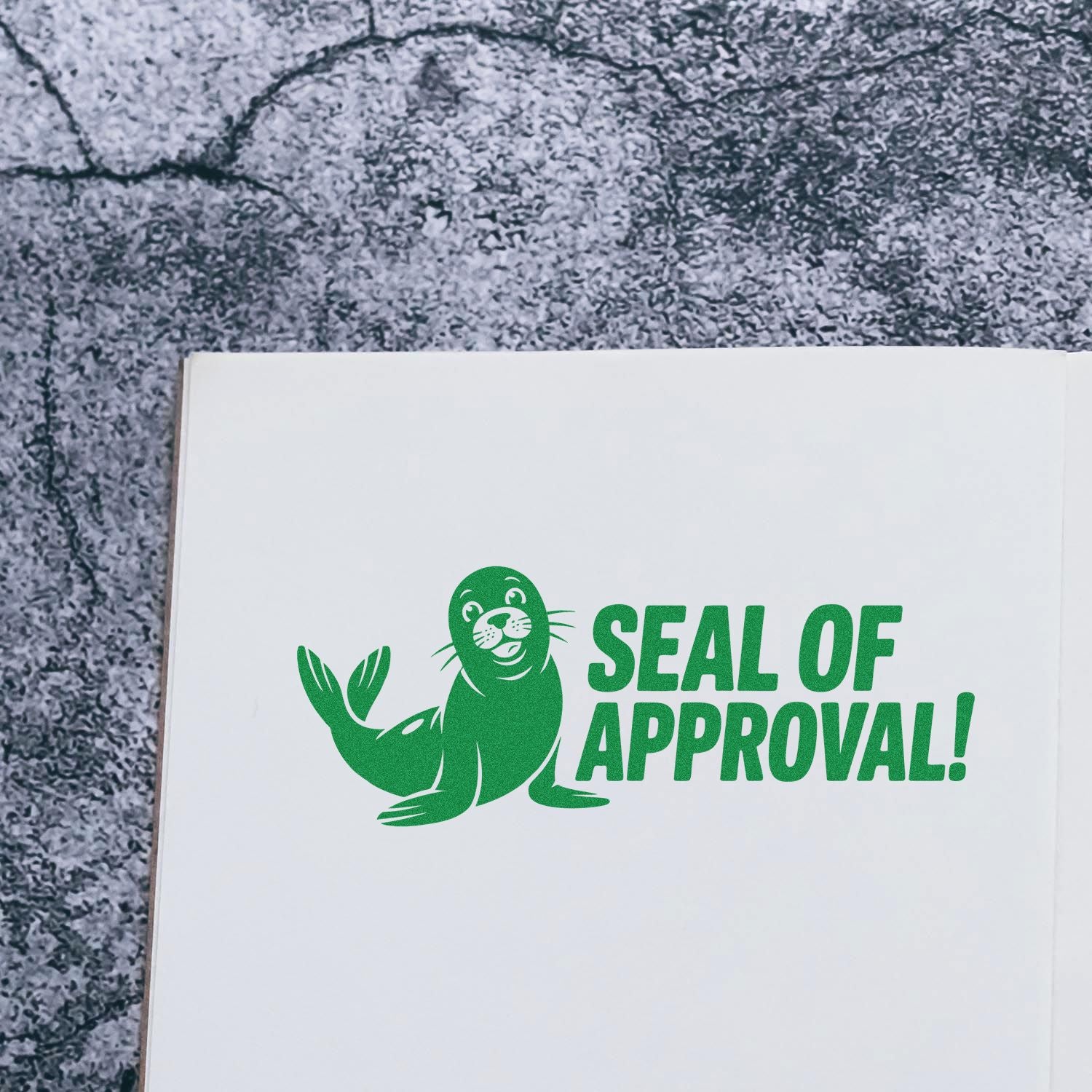 Green stamp seal reading SEAL OF APPROVAL! with a seal icon on white paper and gray textured background.