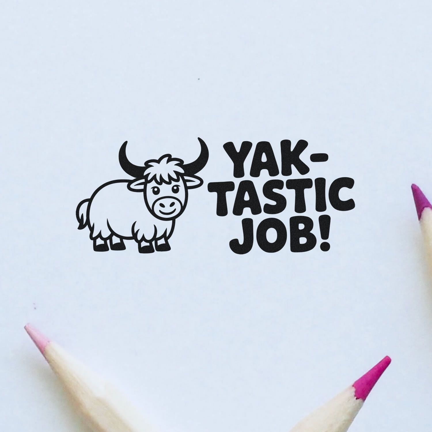 Black yak stamp and seal with YAK-TASTIC JOB! on white paper, accented by pink pencil tips.