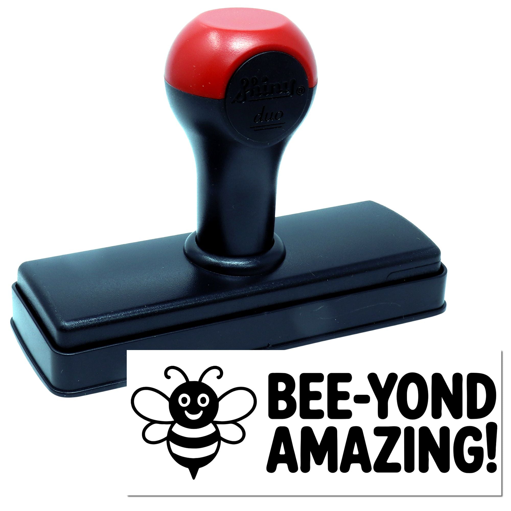 Red-and-black self-inking stamp with bee logo and bold BEE-YOND AMAZING! seal impression.