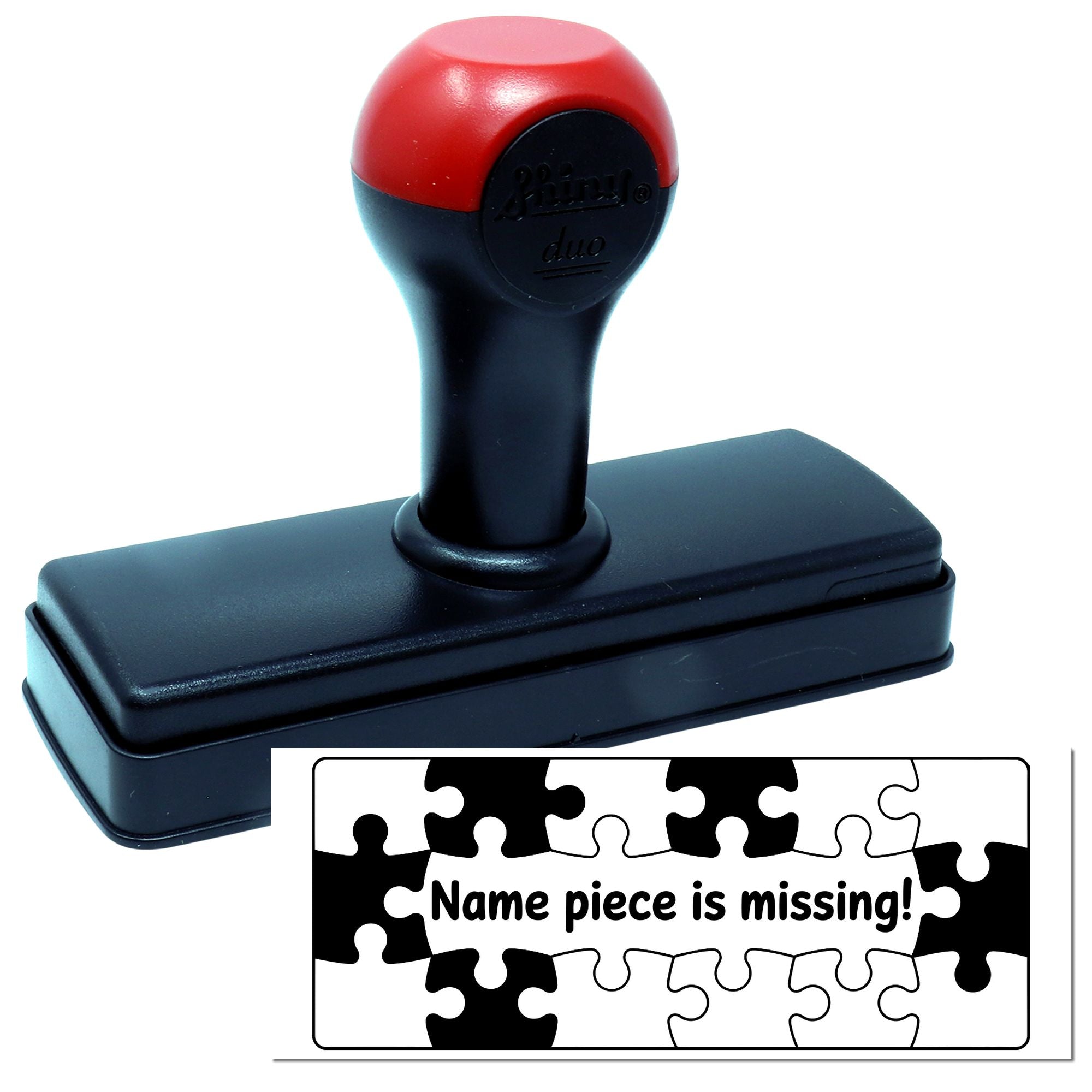 Red-and-black self-inking stamp and seal with rectangular black base; sample imprint shows puzzle pieces and Name piece is missing!