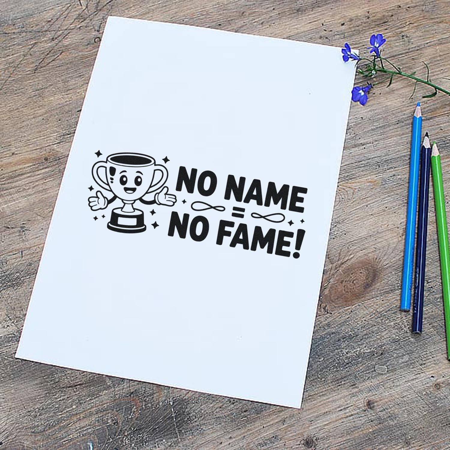 White stamp sheet with black trophy seal reading No Name No Fame, on rustic wood with blue, green, and black pencils.