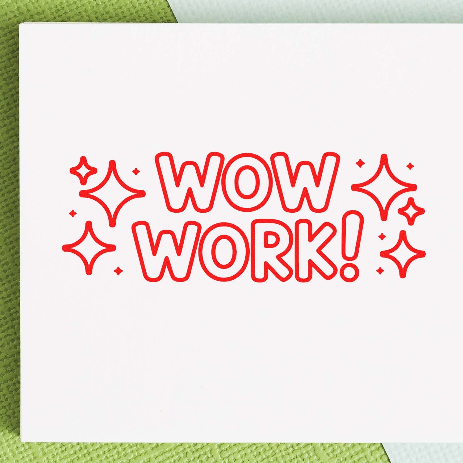Red WOW WORK! stamp and seal design with sparkles on a white card over a green textured background