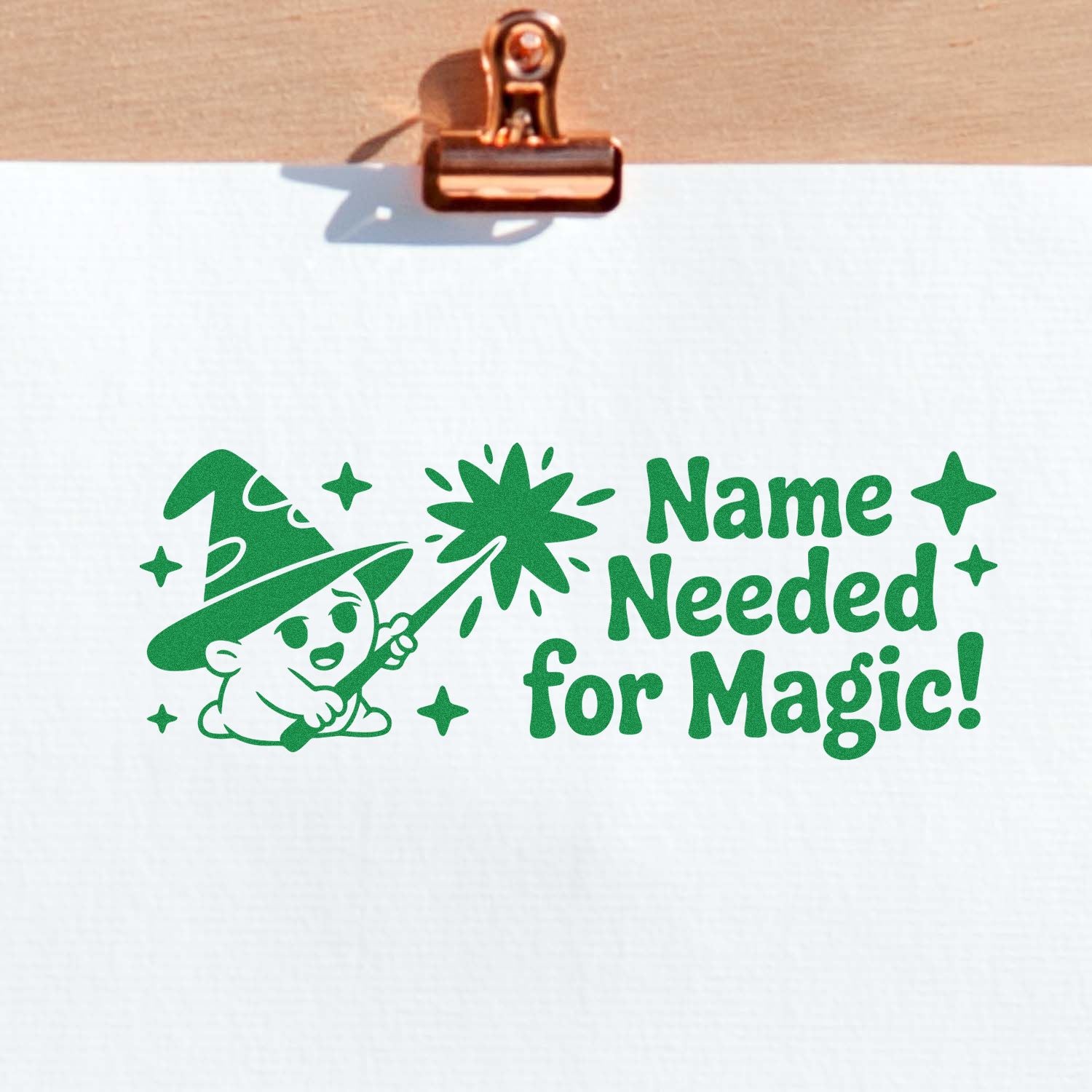 Green custom stamp and seal with wizard and Name Needed for Magic! on white paper, clipped to a board.