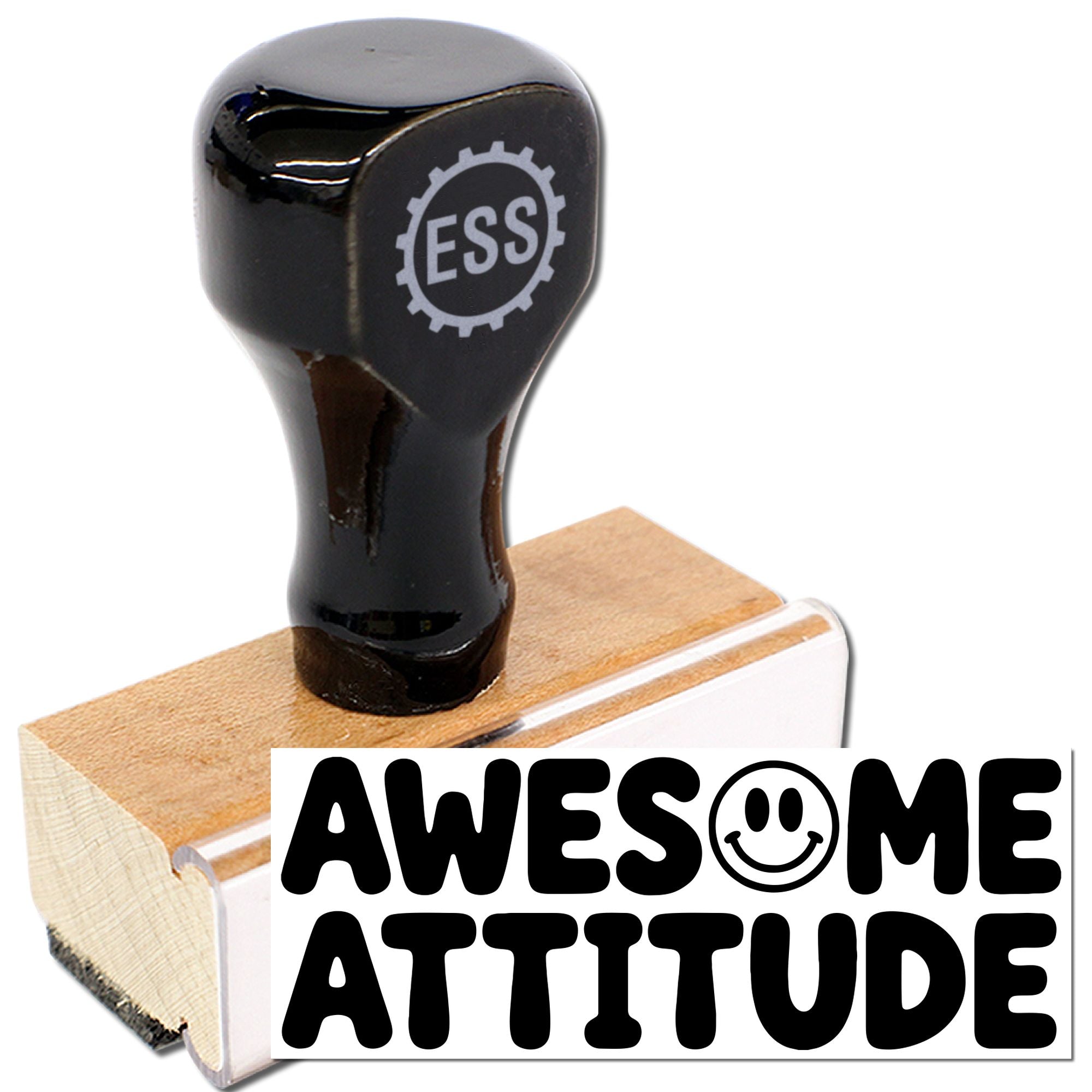 Black rubber stamp and seal on a wooden block, printing bold AWESOME ATTITUDE with a smiley face.