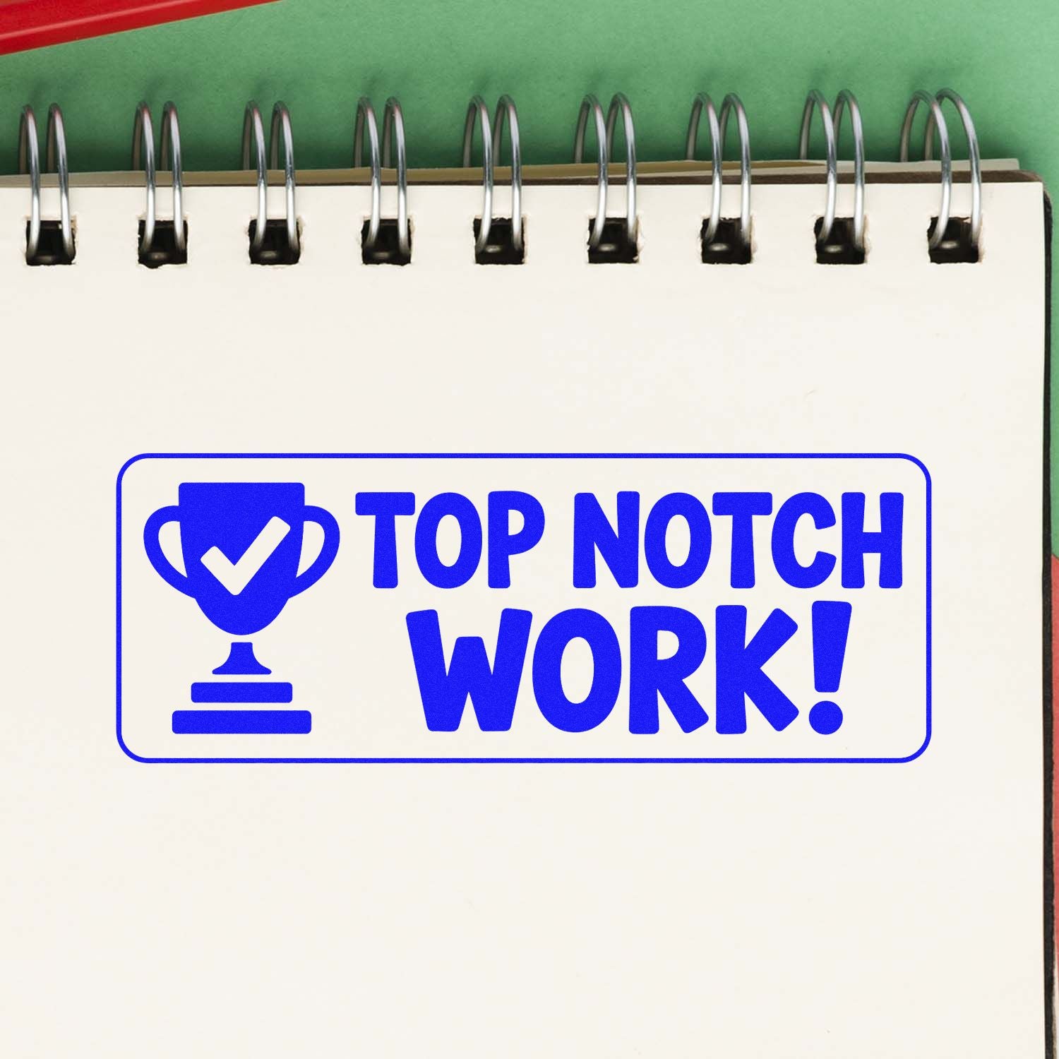 Blue Top Notch Work stamp seal with trophy icon in bright blue on a white spiral notebook, with green background.