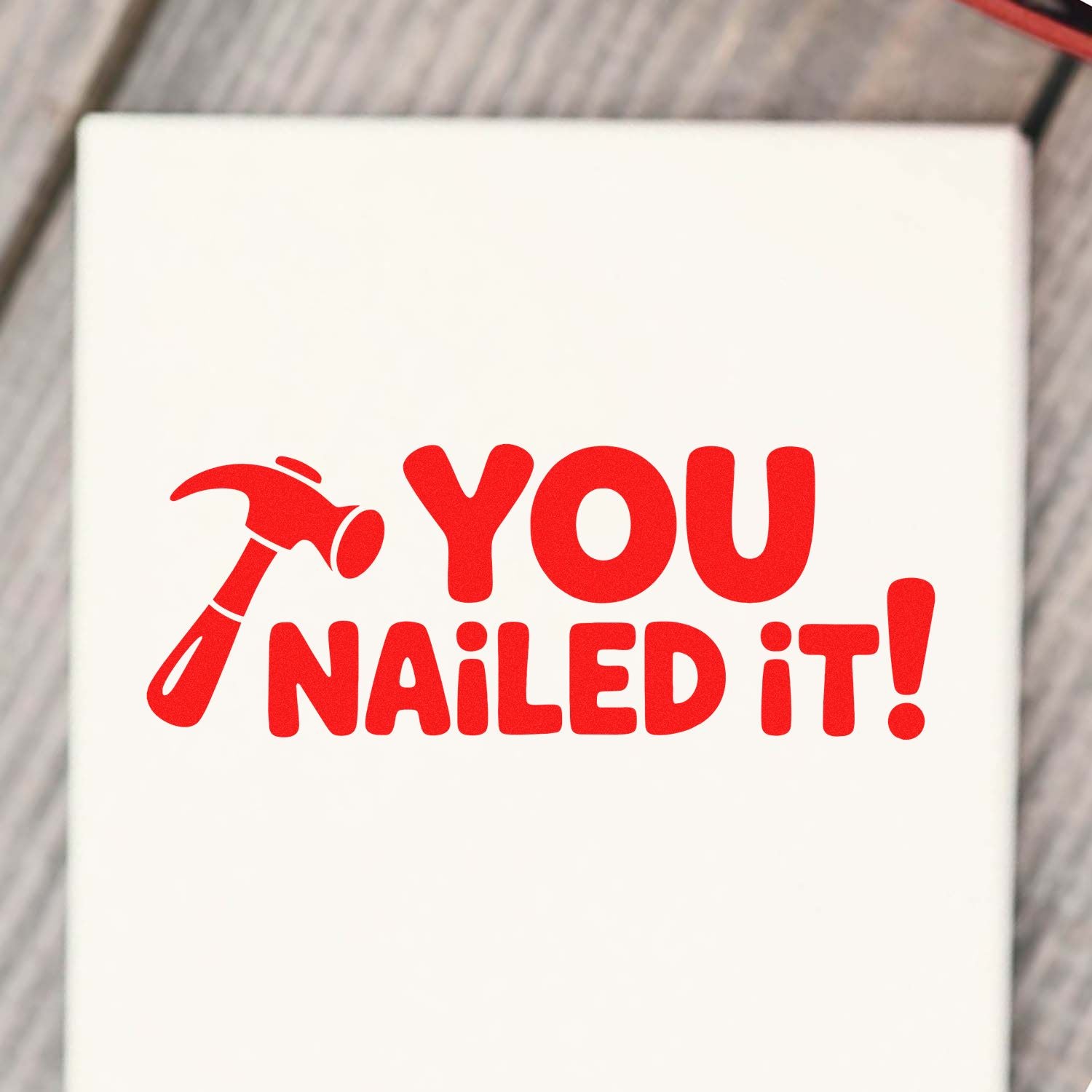 Red hammer-style stamp seal reading YOU NAILED IT! on a white background.