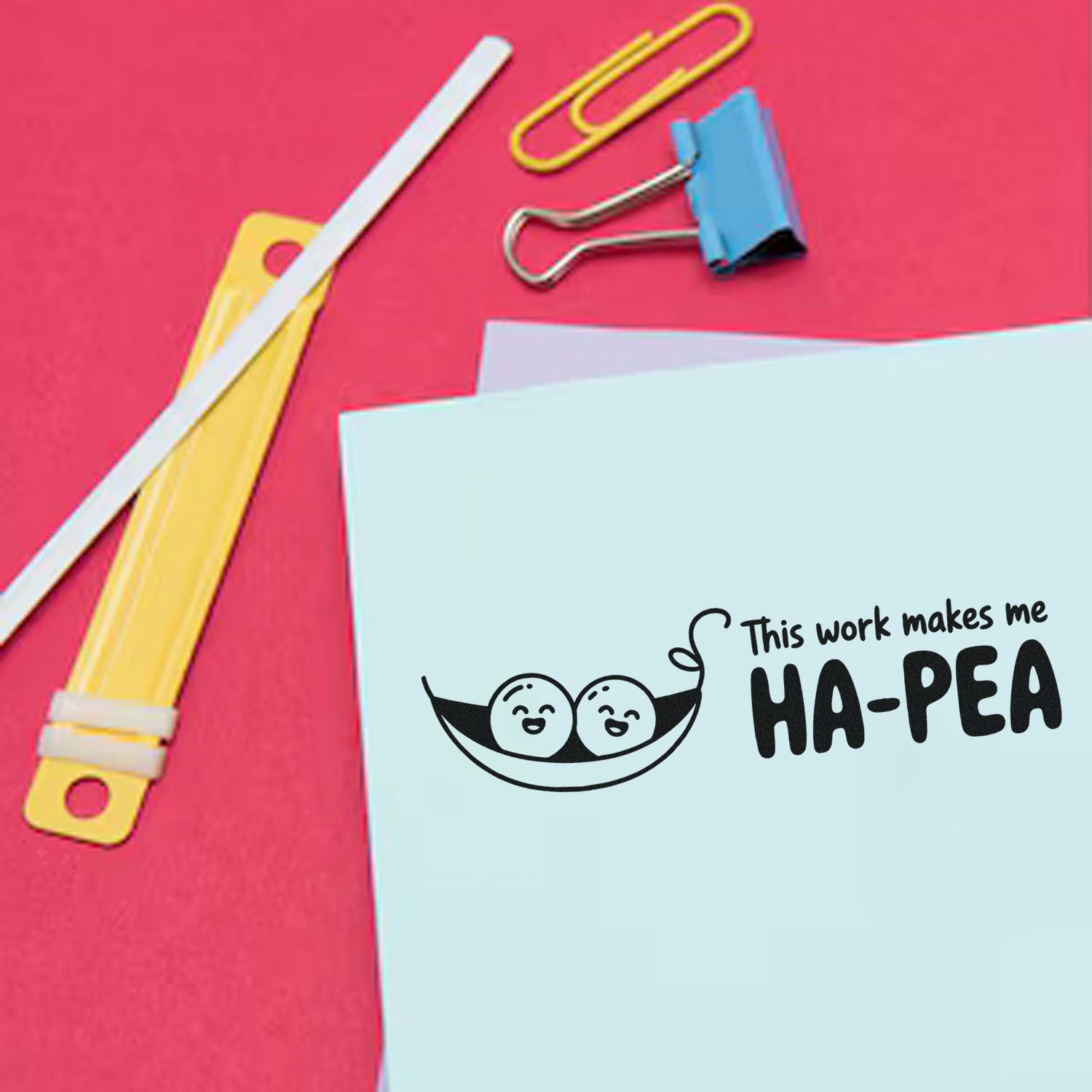 Custom stamp and seal stationery on a pink background, with blue paper, yellow clips, and a playful HA-PEA pea design.