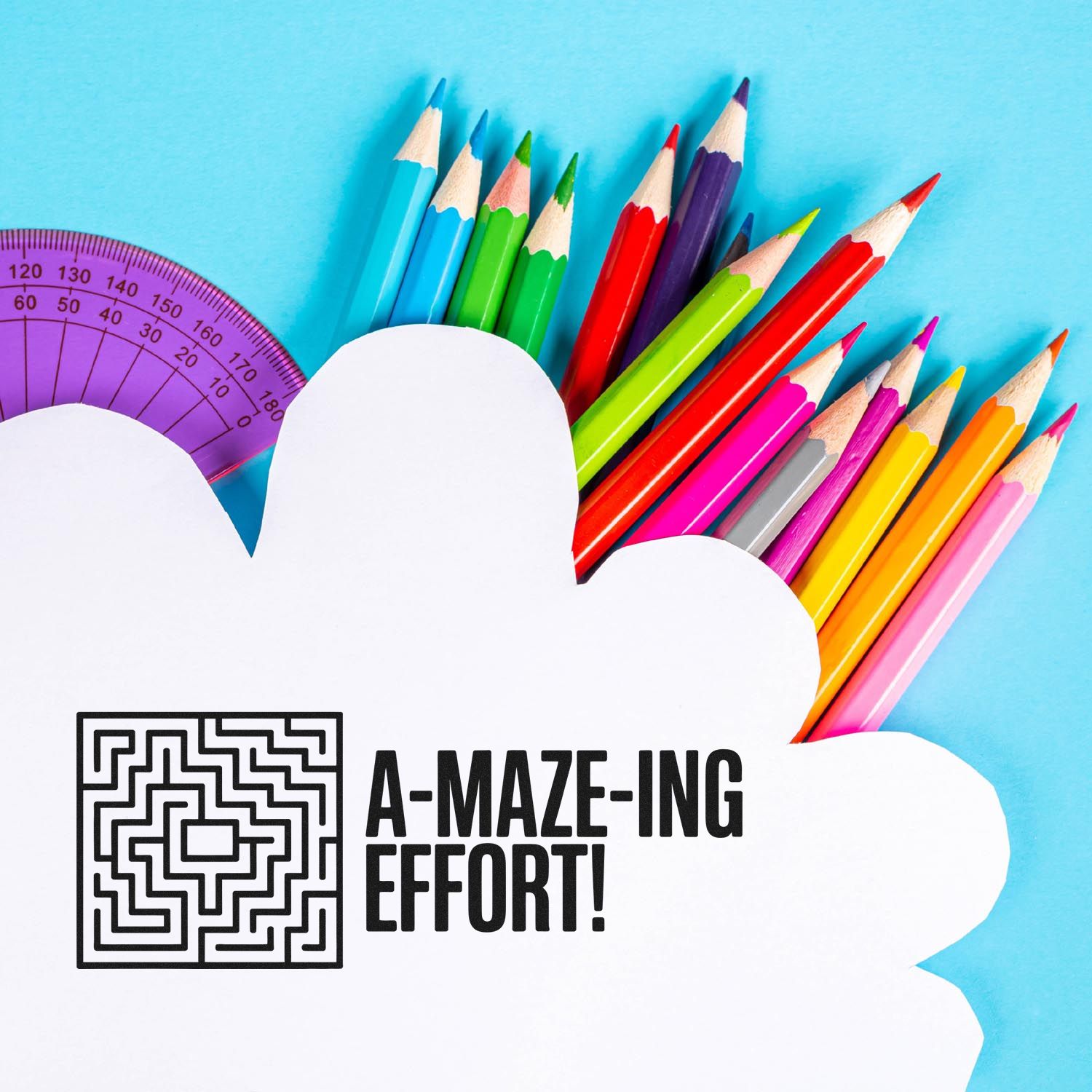 Colorful pencils and purple protractor behind a white cloud-shaped stamp seal with black maze and A-MAZE-ING EFFORT! text.