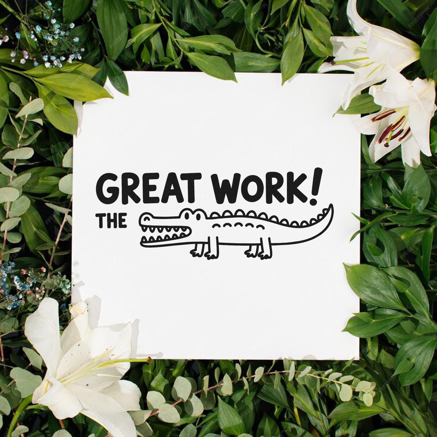 White rubber stamp seal with black Great Work! crocodile design, surrounded by green leaves and white lilies.