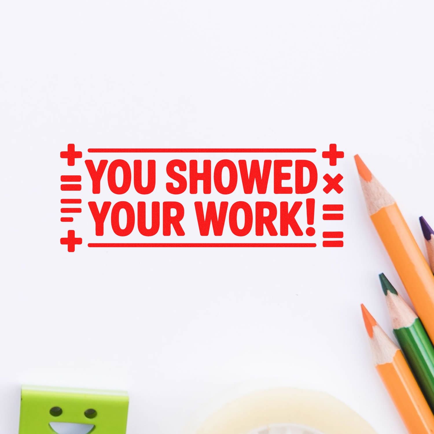 Red self-inking stamp seal reading You showed your work! with colored pencils on a white background.