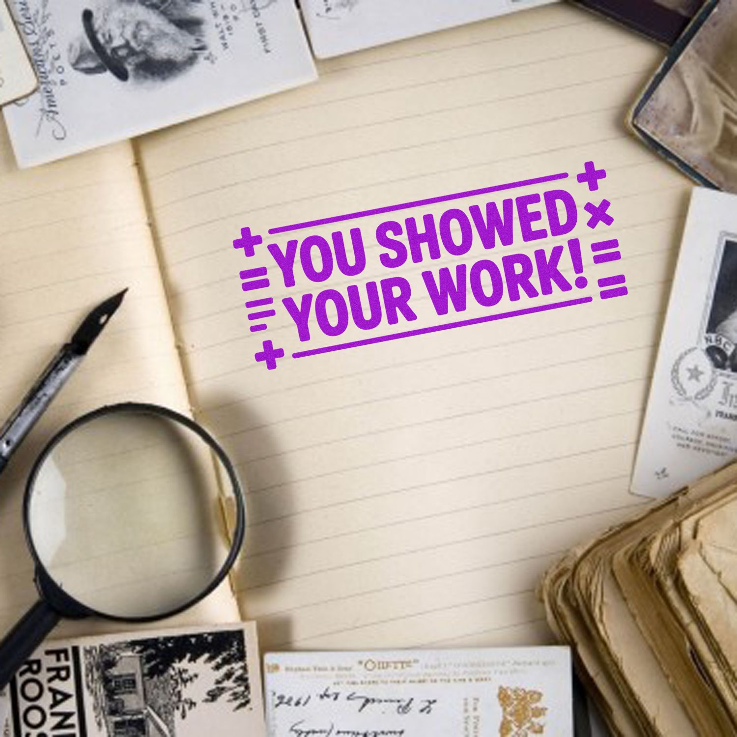 Purple You showed your work! text on cream notebook, with vintage stamp and seal cards, magnifying glass, and pen.