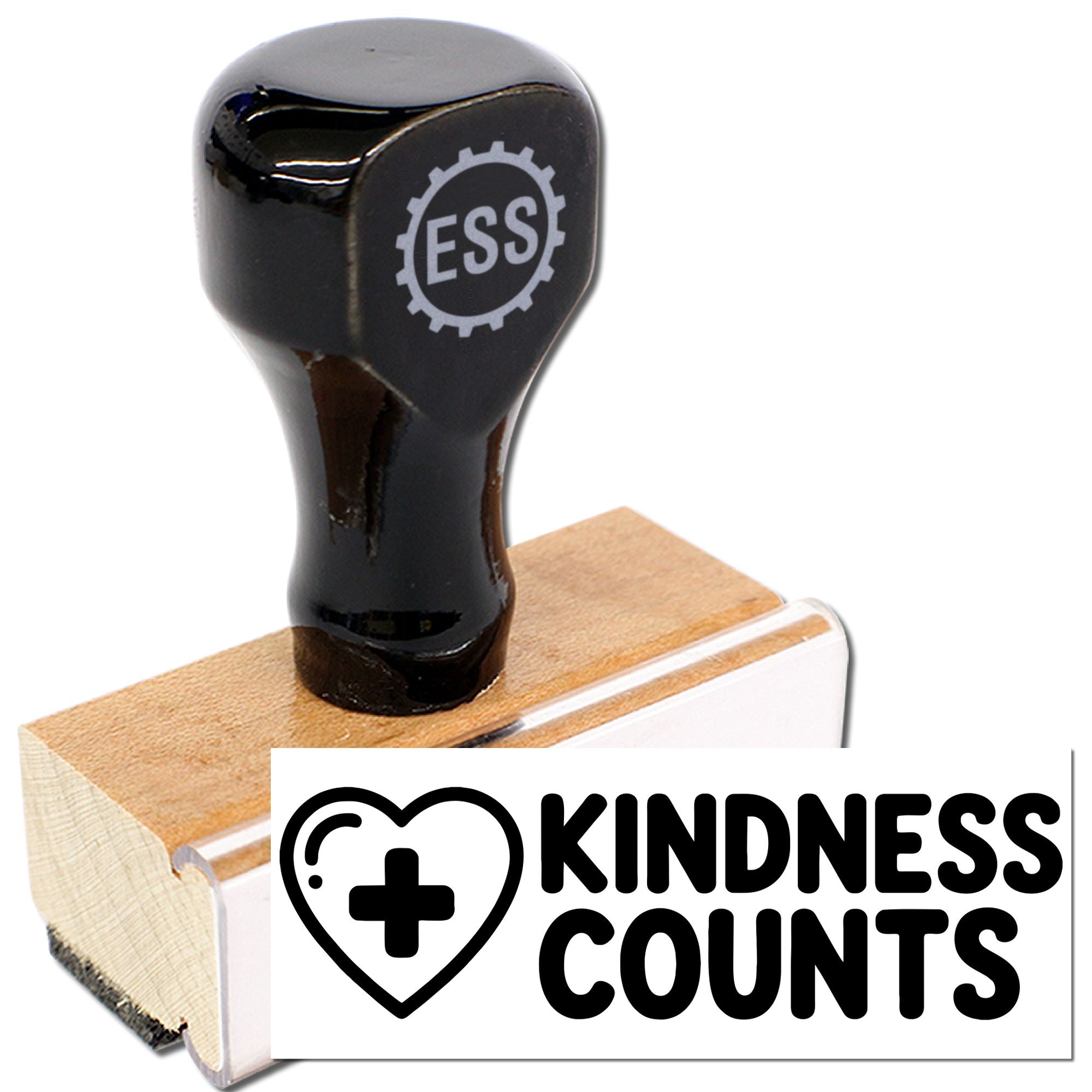 Black ESS rubber stamp on wooden base with Kindness Counts seal and heart-plus logo.
