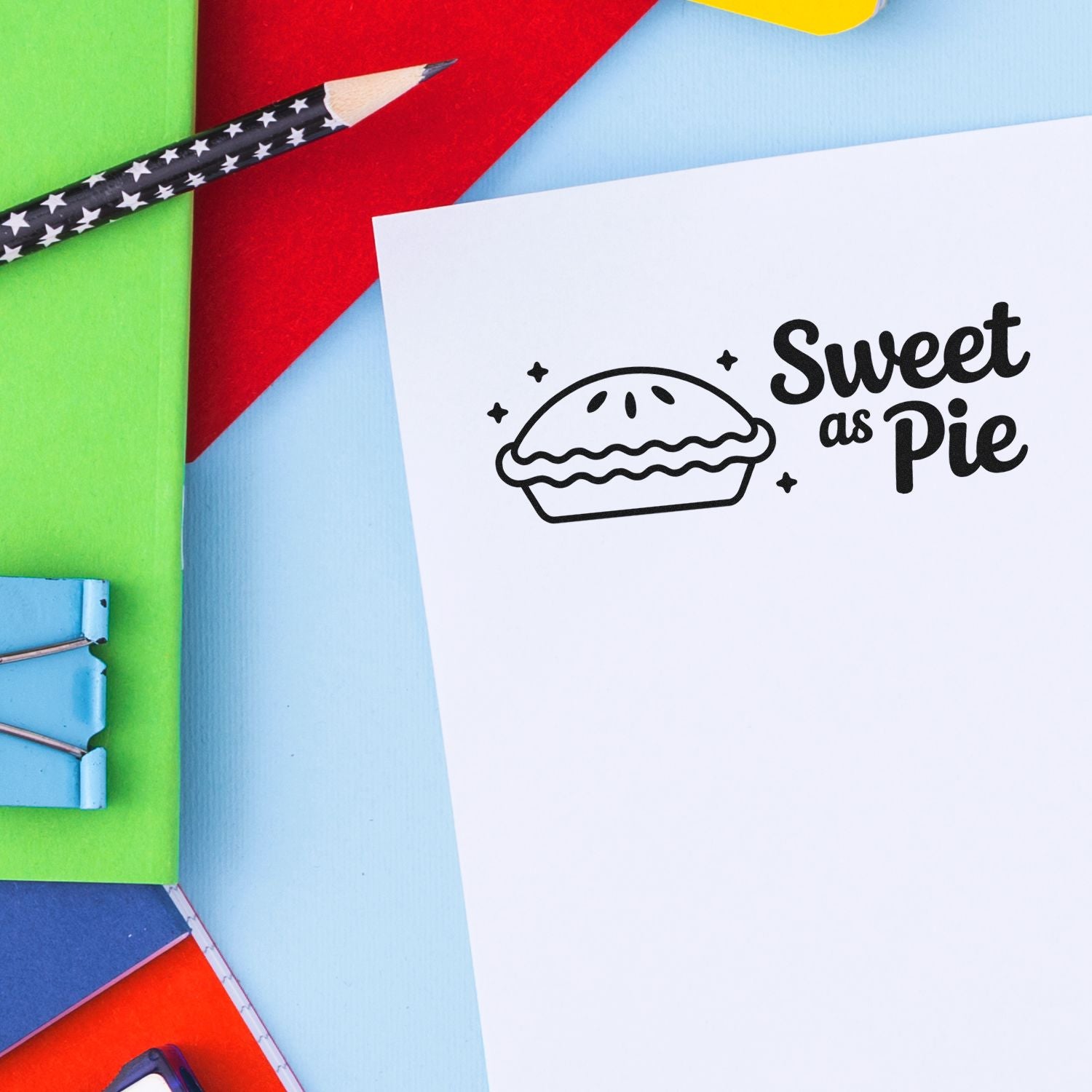 Sweet as Pie stamp and seal on white card, with pie icon, surrounded by colorful stationery on blue, red, green, and yellow background.