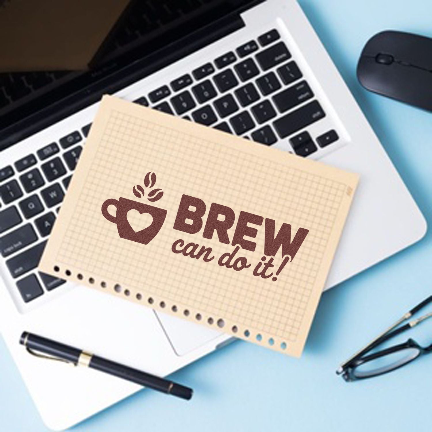 Beige grid stamp seal with brown coffee cup icon and BREW can do it! over a laptop, pen, mouse, and glasses.