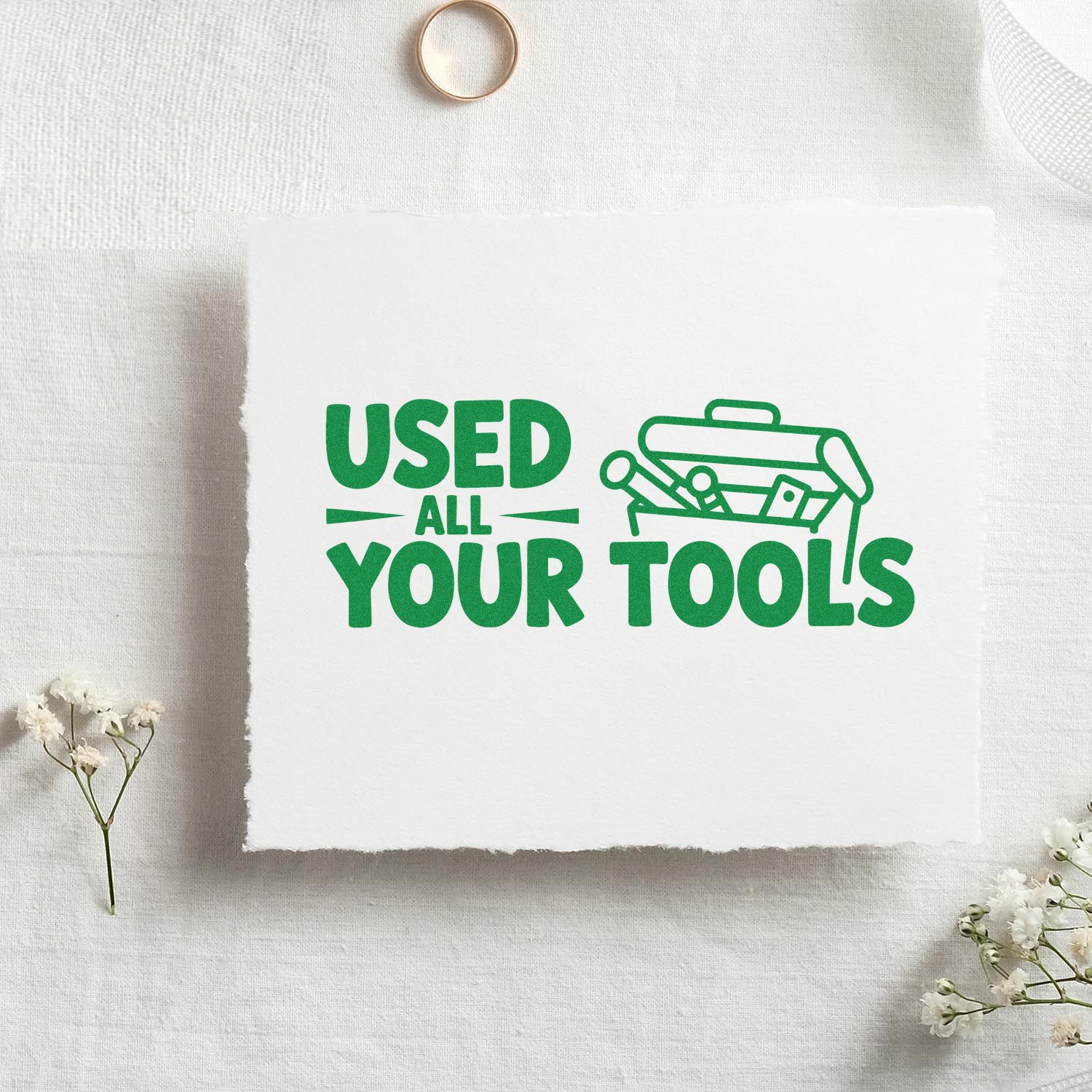 Green used-all-your-tools stamp design with toolbox icon on white textured paper for stamp and seal products.