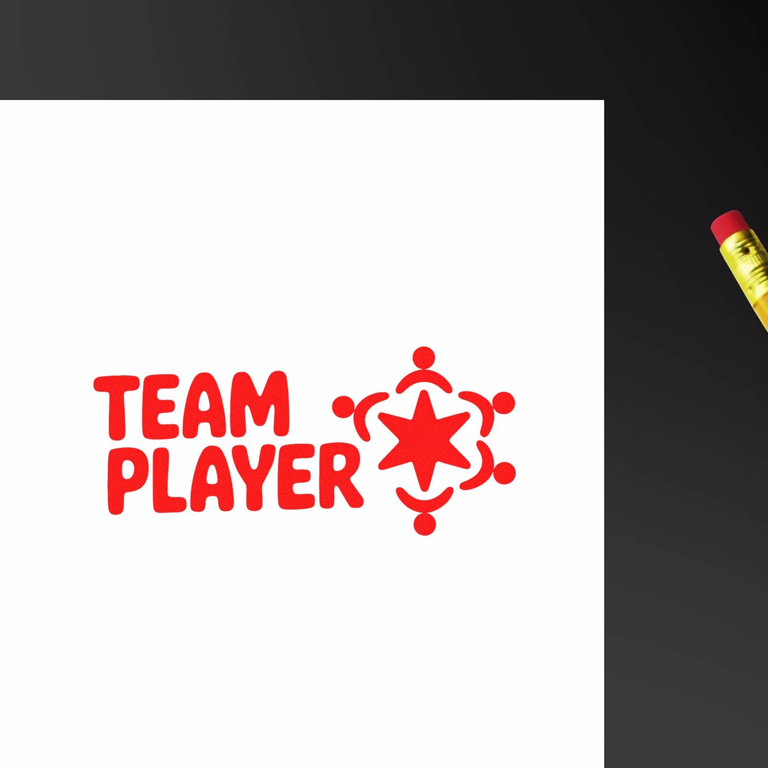 Red TEAM PLAYER stamp and seal with star-and-people icon on white paper, beside a yellow pencil on a dark background.