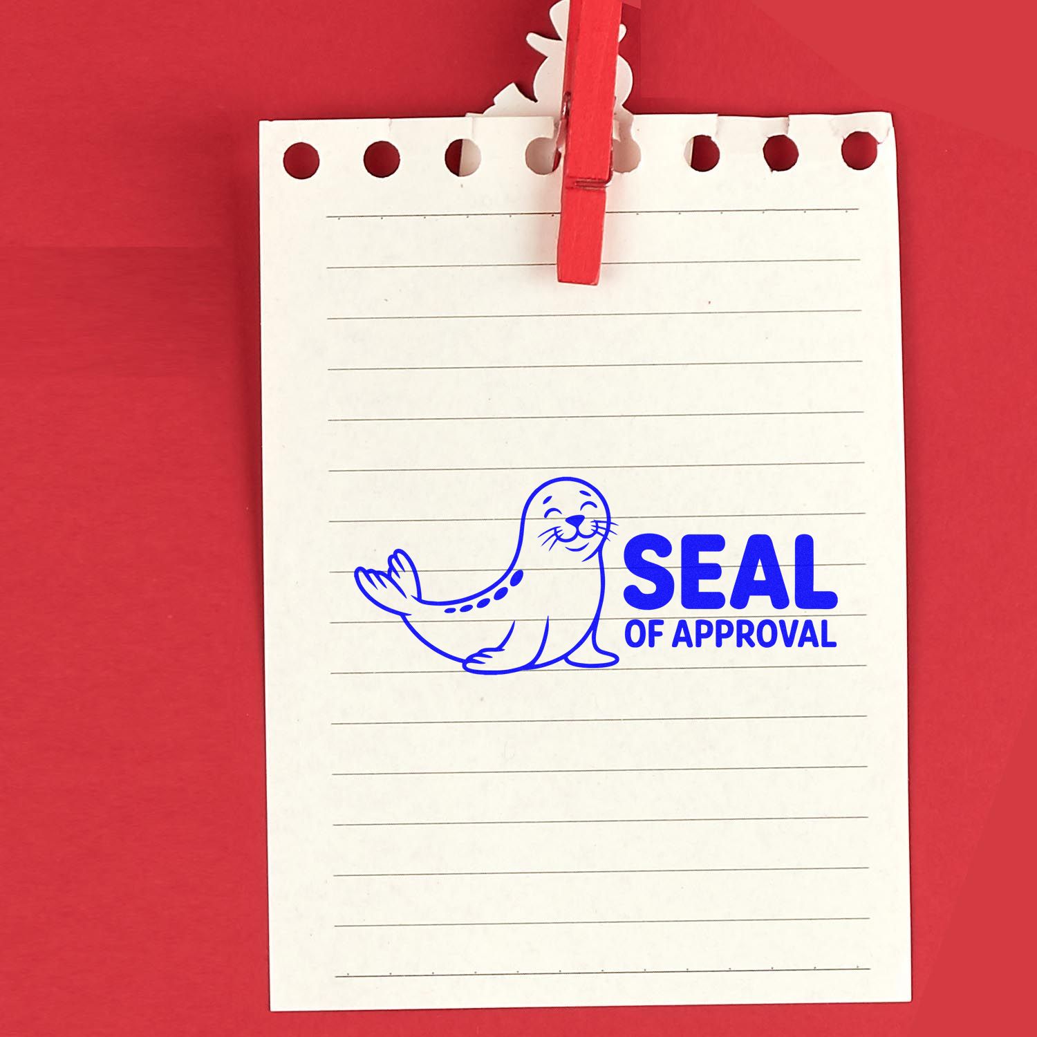 White lined notepad clipped with red clothespin, featuring a blue seal of approval stamp and seal icon on a red background.