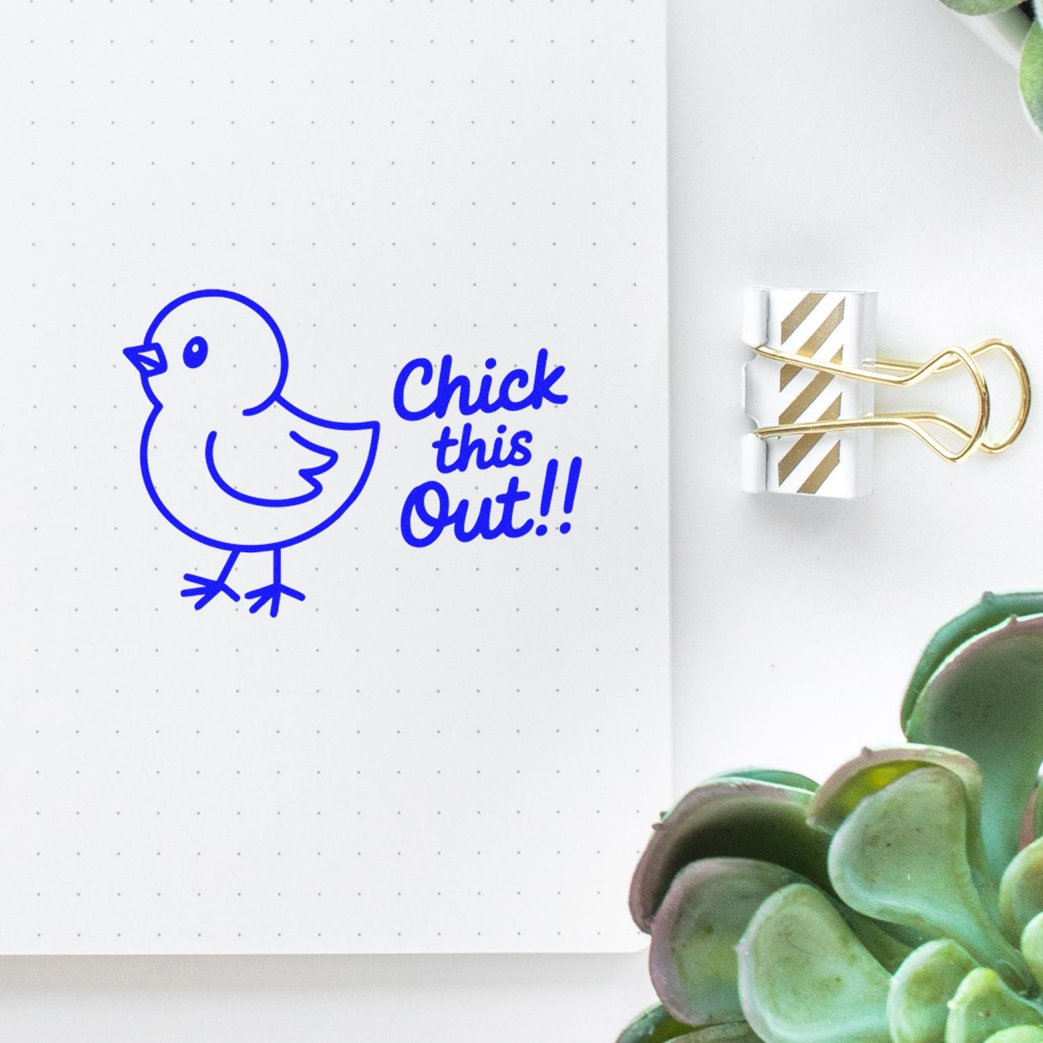 Blue chick stamp with Chick this Out!! on dotted notebook page, clipped with gold striped paper seal.