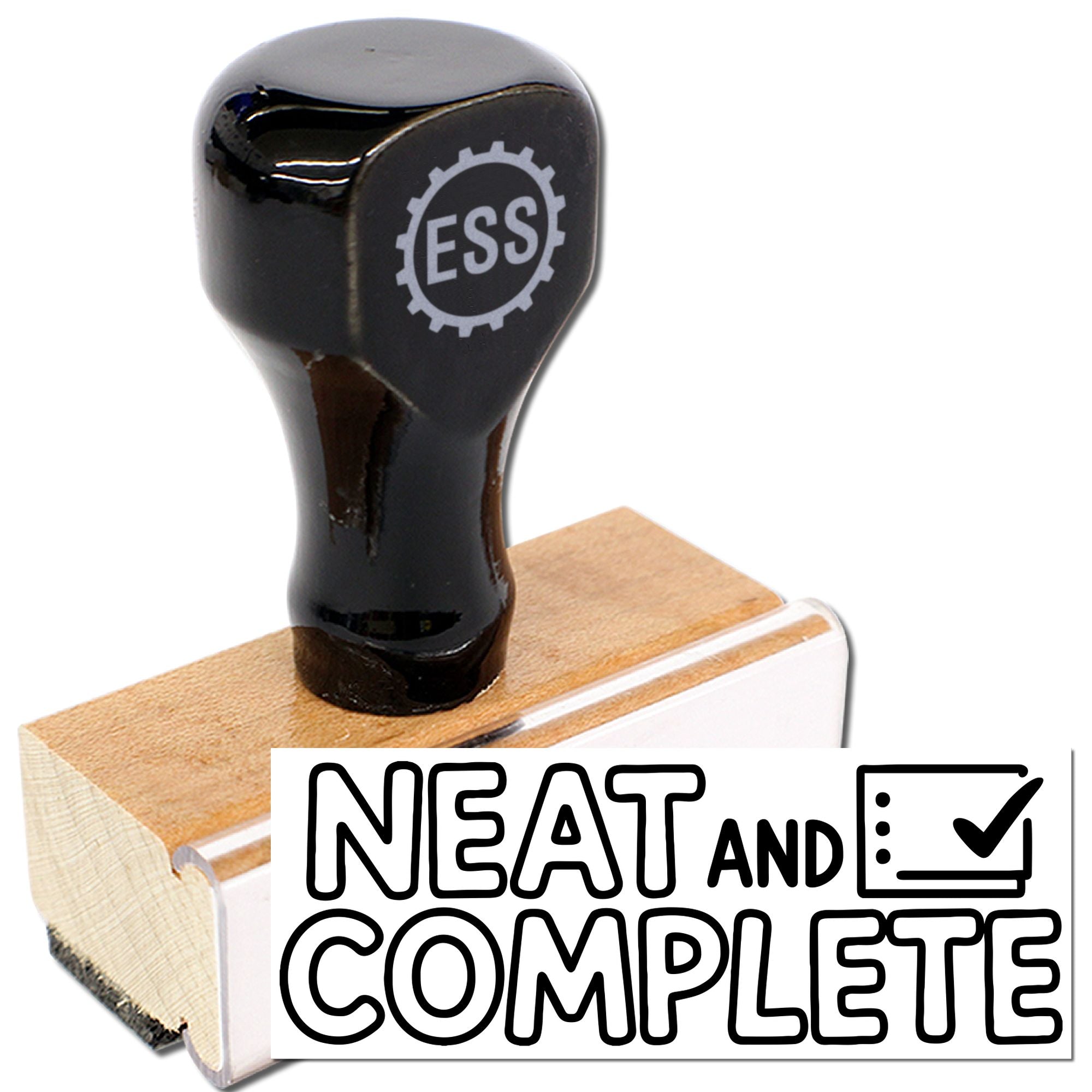 Black ESS rubber stamp with wooden base and NEAT AND COMPLETE seal design on white background.