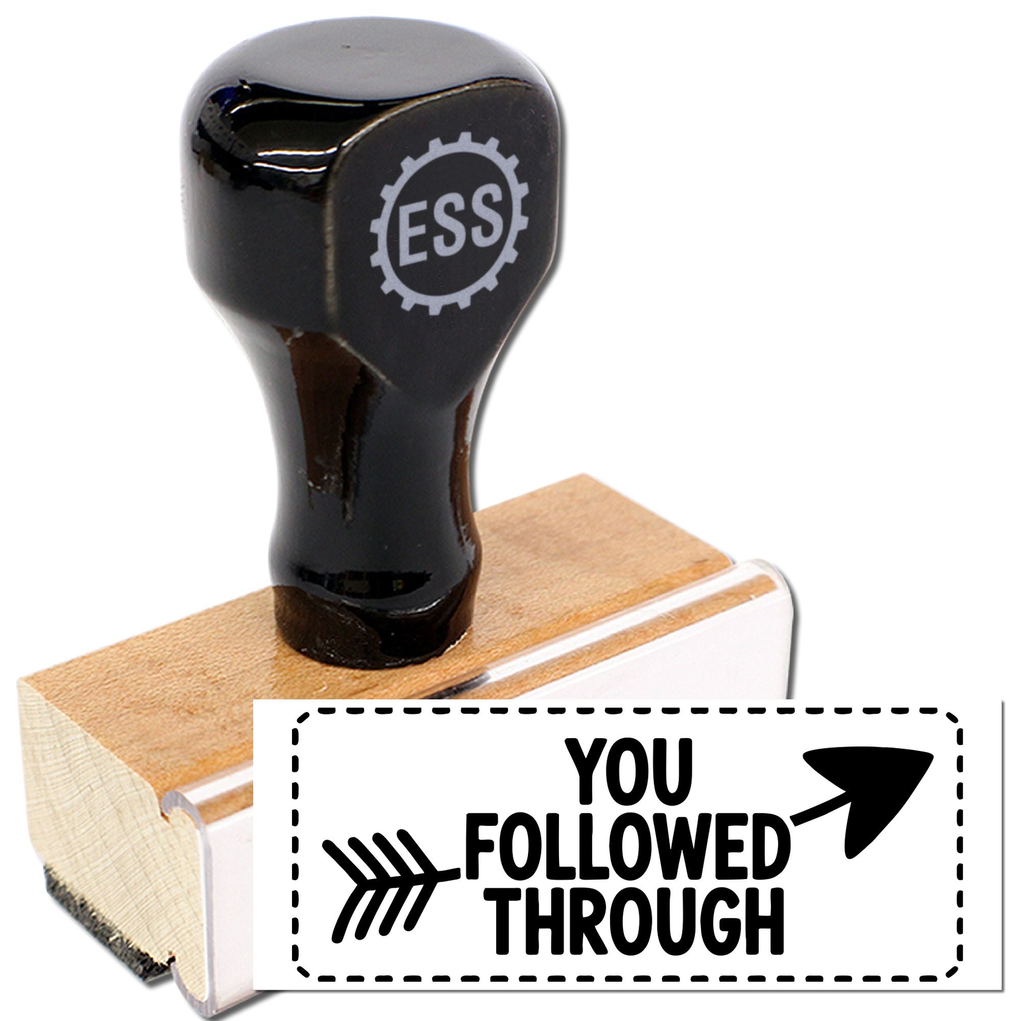 Black rubber stamp and seal on wooden handle with white YOU FOLLOWED THROUGH impression and arrow icon.