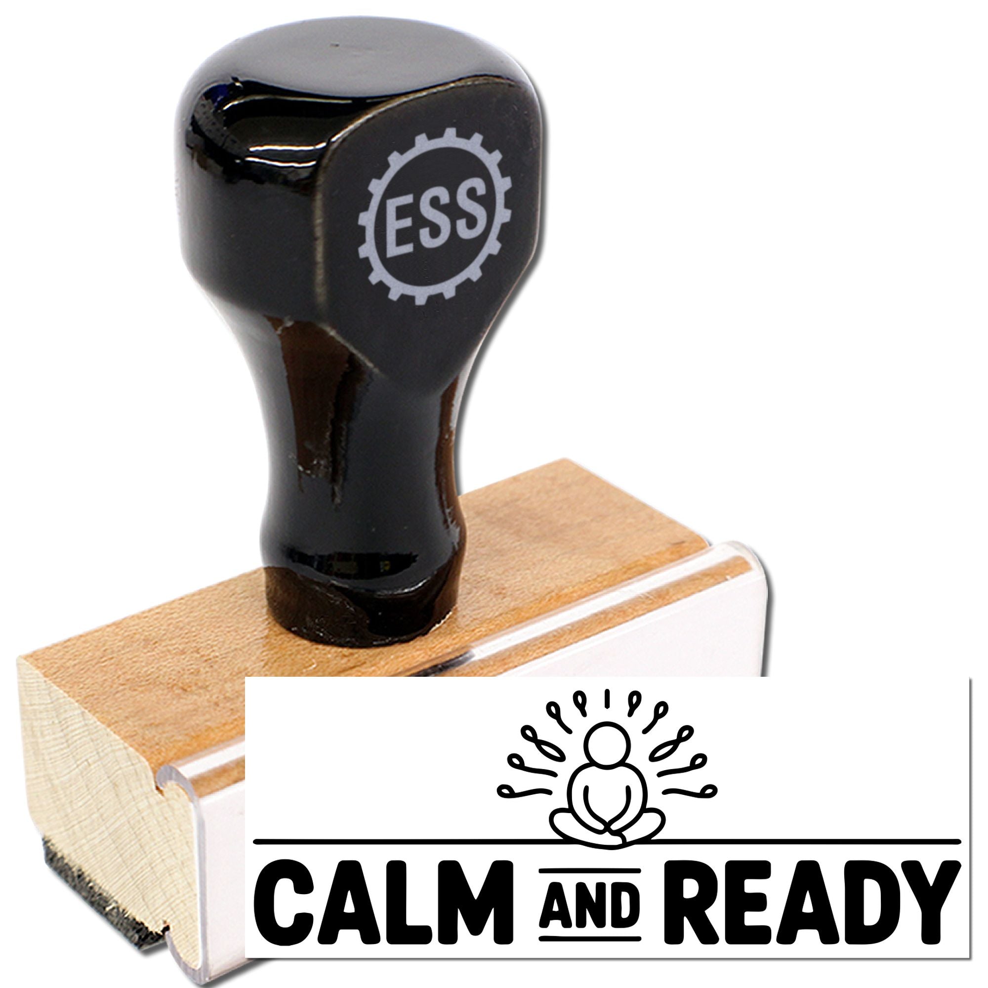 Black rubber seal stamp with ESS logo on light wood block, showing a white CALM AND READY impression.
