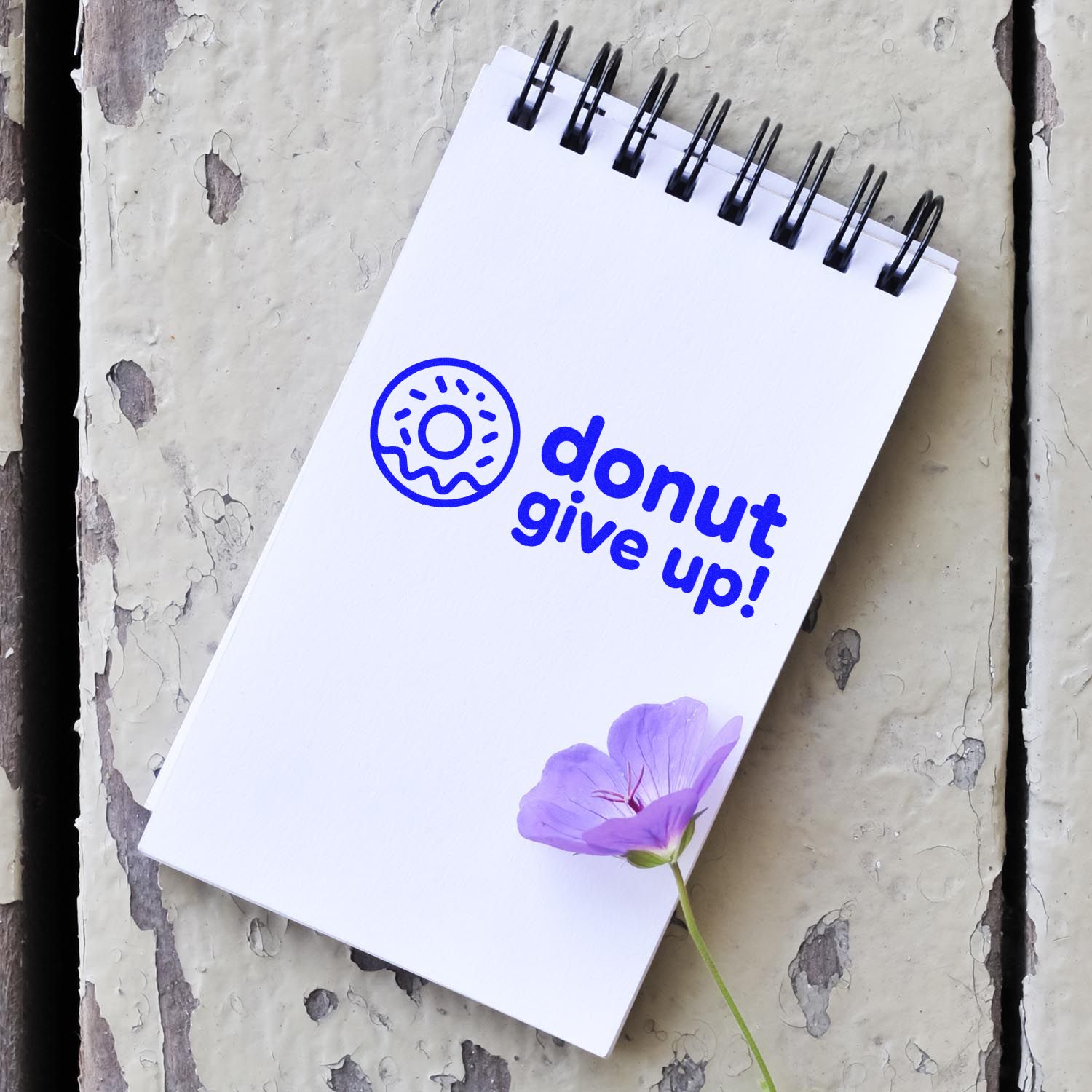 Blue donut give up! custom stamp on white spiral notebook, with donut icon and purple flower.