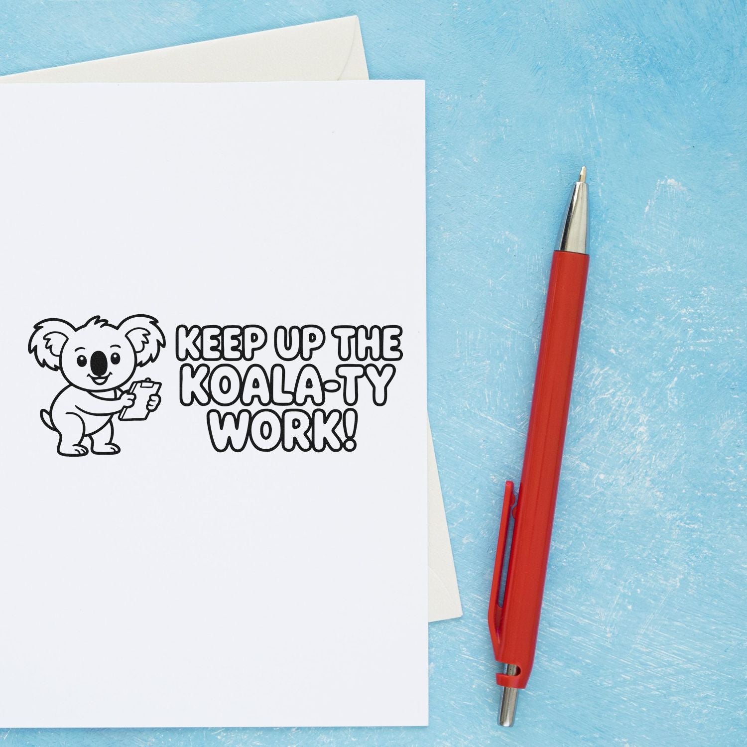 Koala-themed stamp and seal on white paper: black Keep Up the Koala-ty Work! design with red pen on blue background.