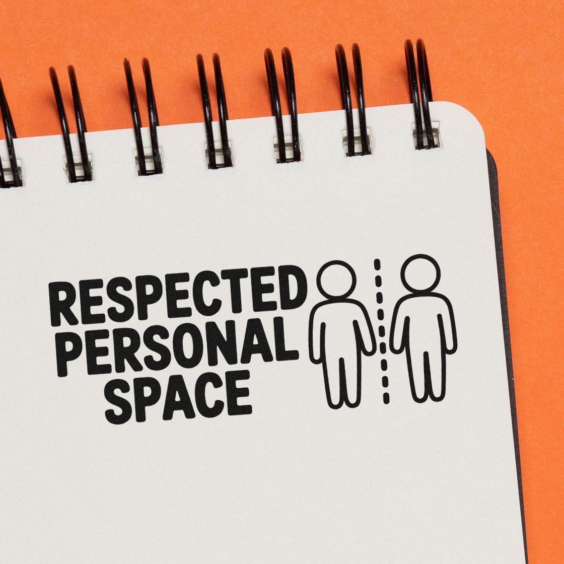 Black personal-space stamp seal design on white spiral notebook, with two figures and a dotted divider on orange background.