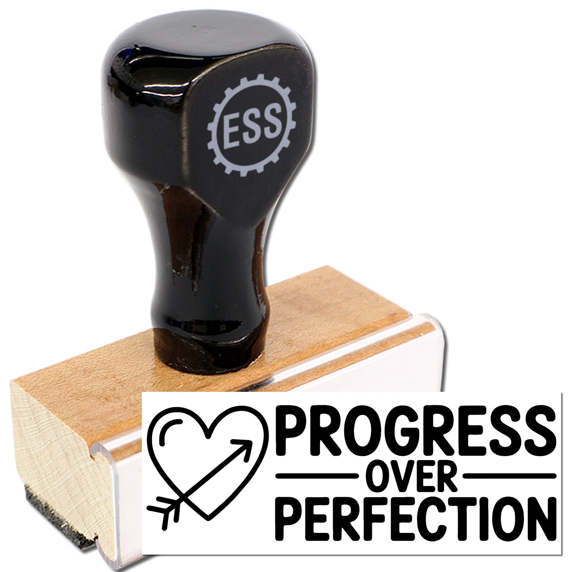 Black ESS rubber stamp on wooden seal block with white Progress Over Perfection design and heart-arrow icon