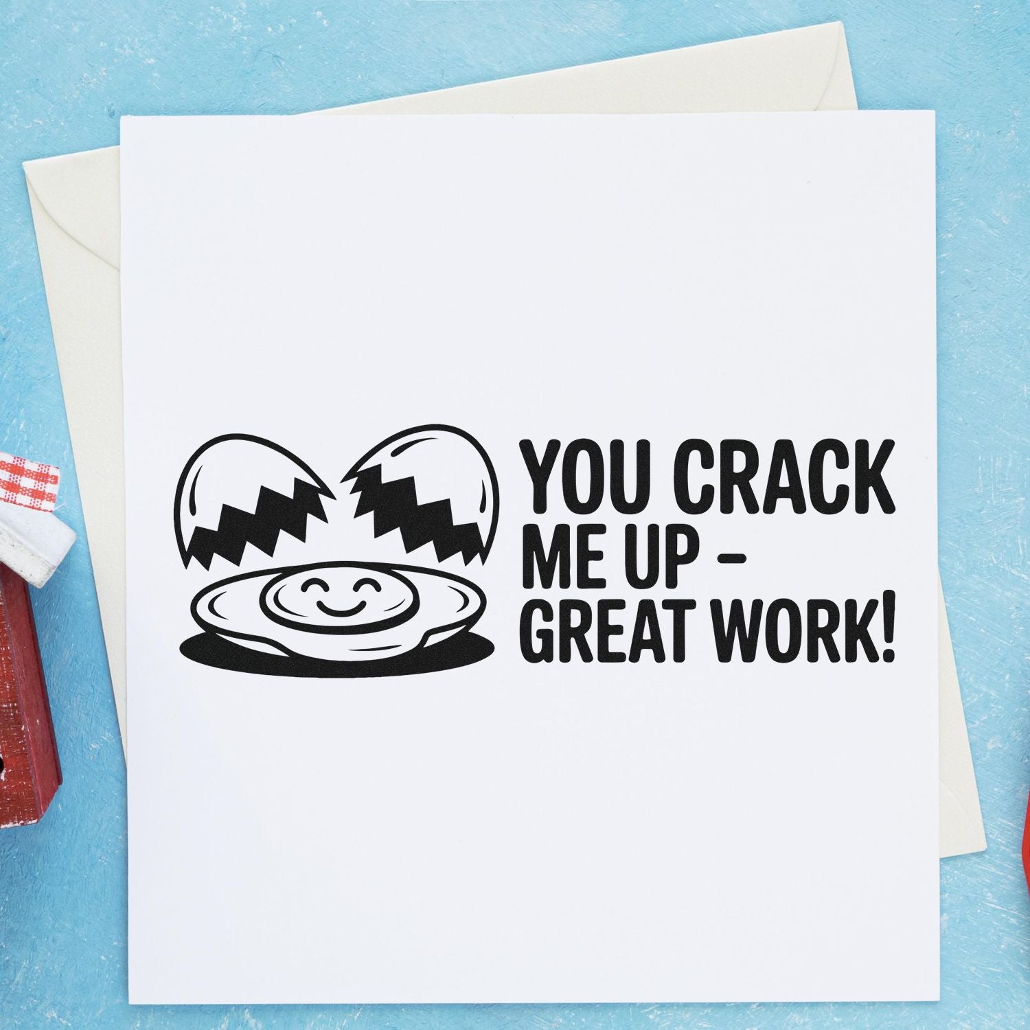 Black stamp and seal with cracked egg and smiley yolk saying You crack me up great work! on white card with blue background.