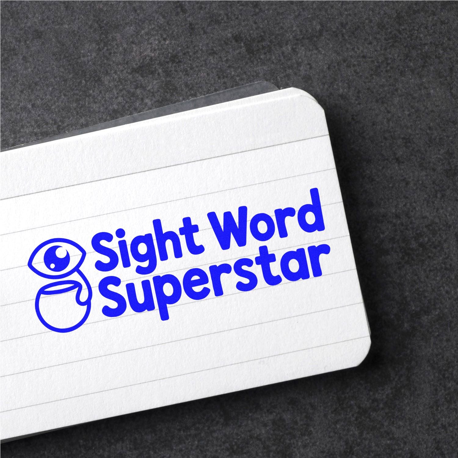 Blue Sight Word Superstar stamp and seal on a white lined card, with bold blue logo on a dark textured background.