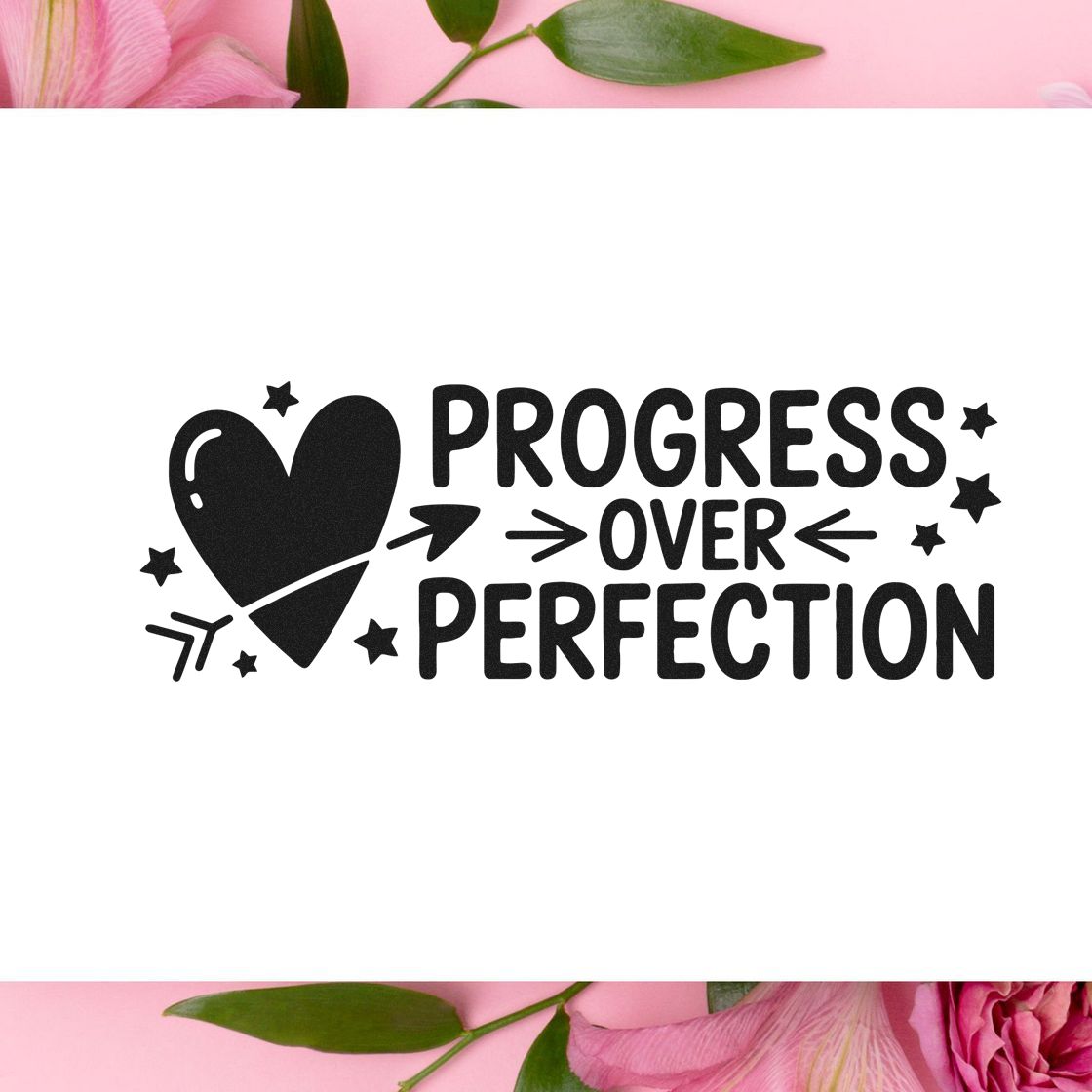 Black Progress Over Perfection stamp seal with heart, arrows and stars on white, framed by pink floral accents.