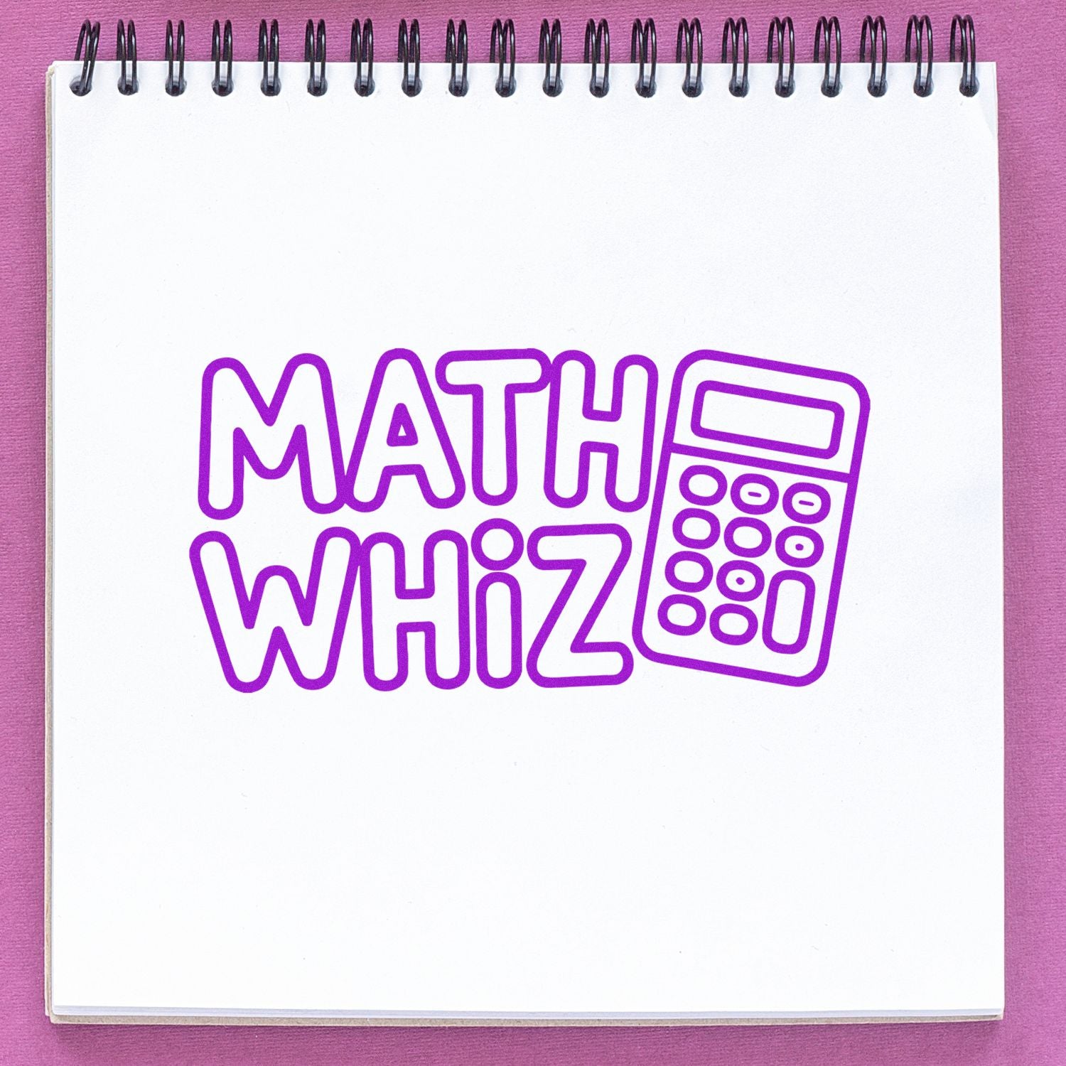 Purple MATH WHIZ stamp and calculator seal on white spiral notebook against a pink background.