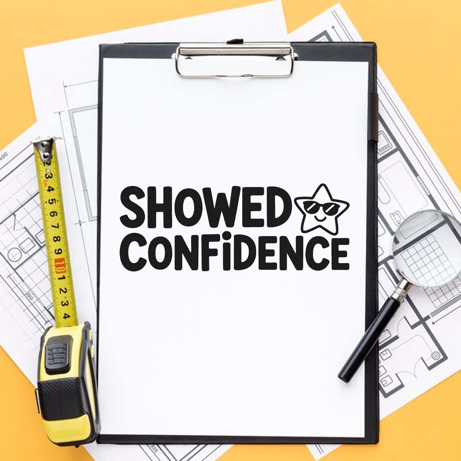 Custom stamp and seal on clipboard, bold black SHOWED CONFIDENCE logo over architectural plans on a yellow workspace.
