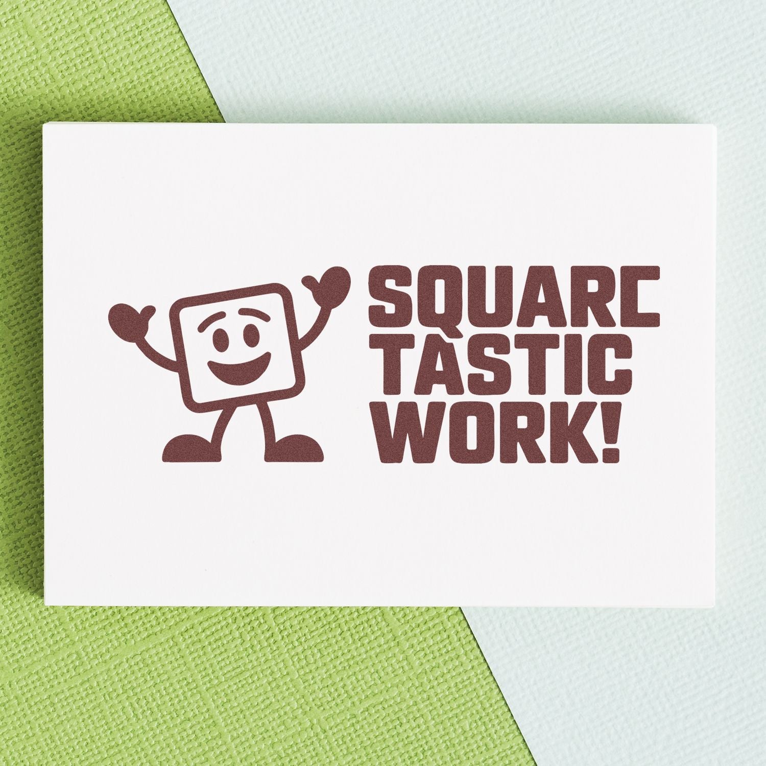 Brown square stamp seal reading SQUARE TASTIC WORK! with smiling mascot on white card over green textured background.