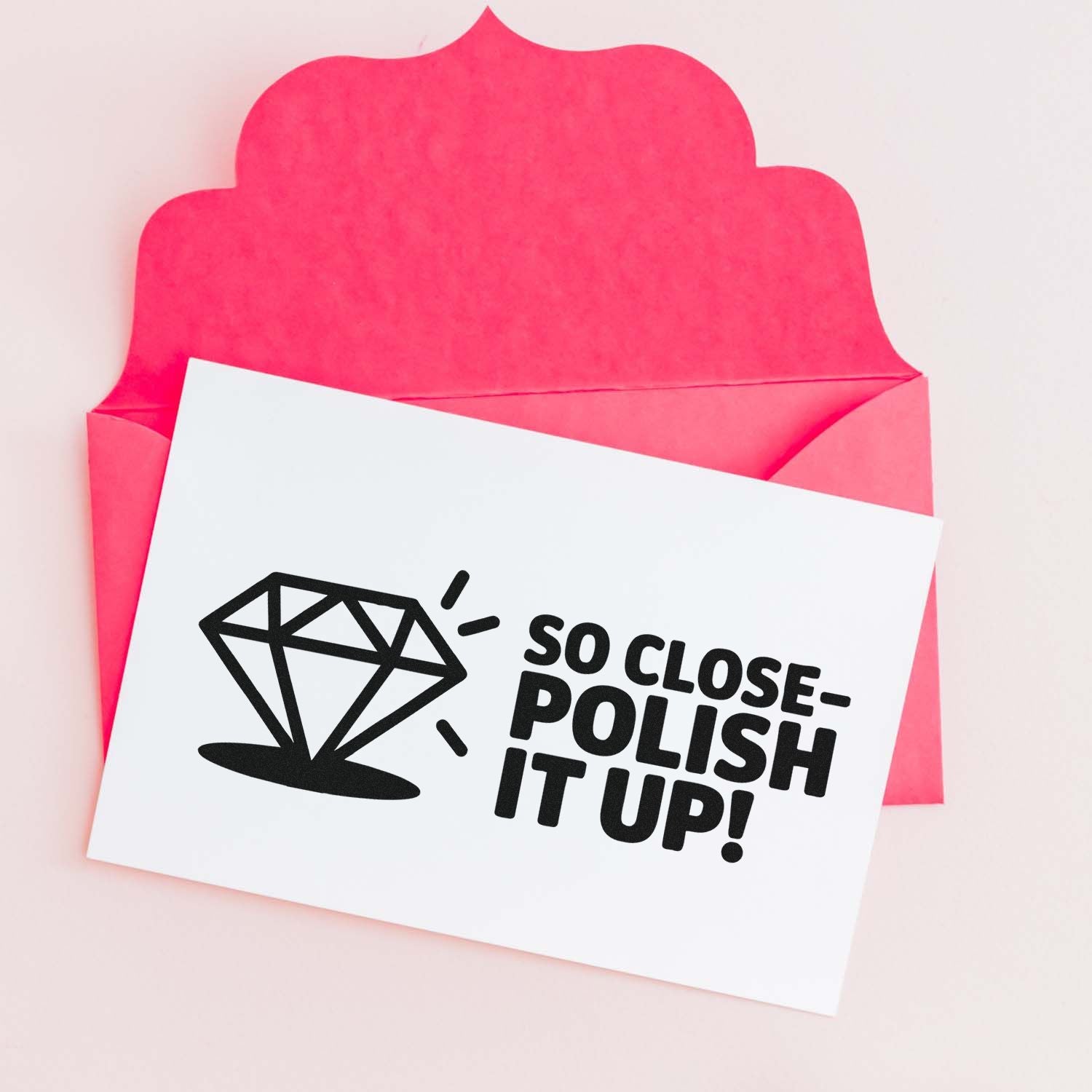 Pink envelope with white stamp and seal card, black diamond icon, and So Close- Polish It Up! text.