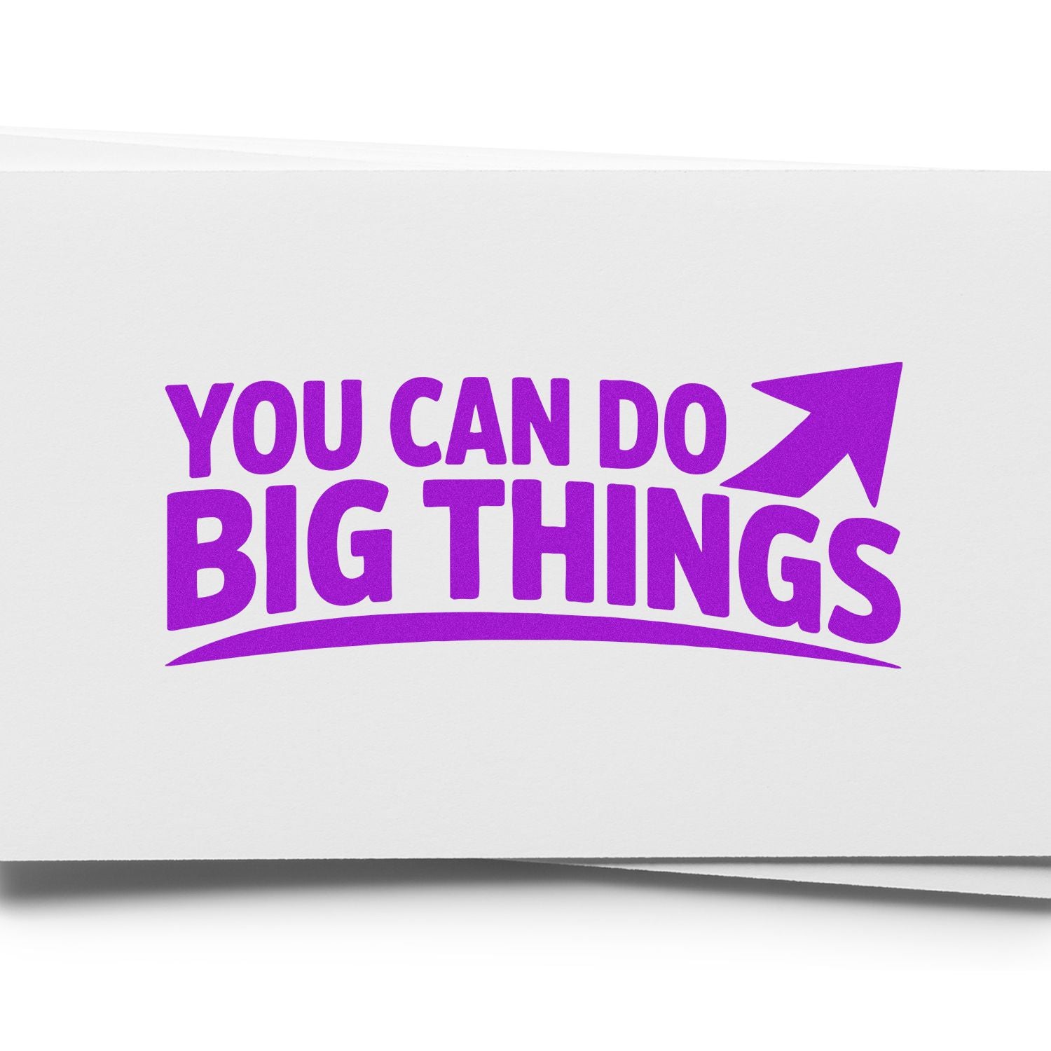 Purple motivational rubber stamp reading You Can Do Big Things with upward arrow on white paper.