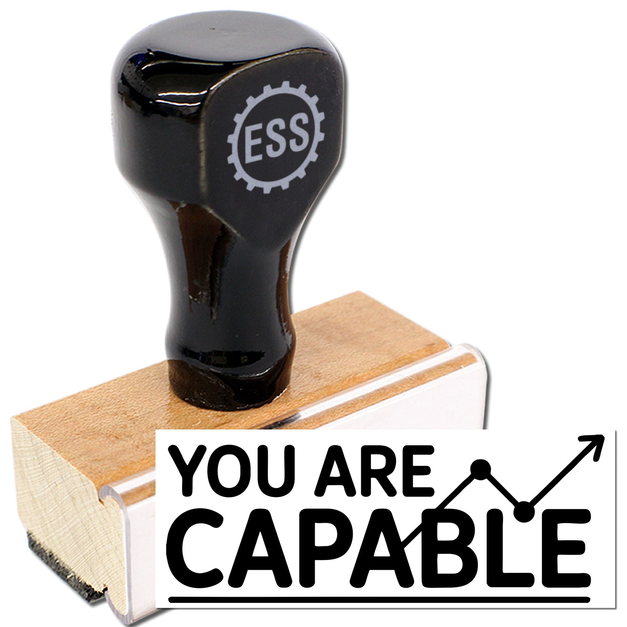Black ESS stamp and wooden seal block with bold YOU ARE CAPABLE text and upward graph icon.