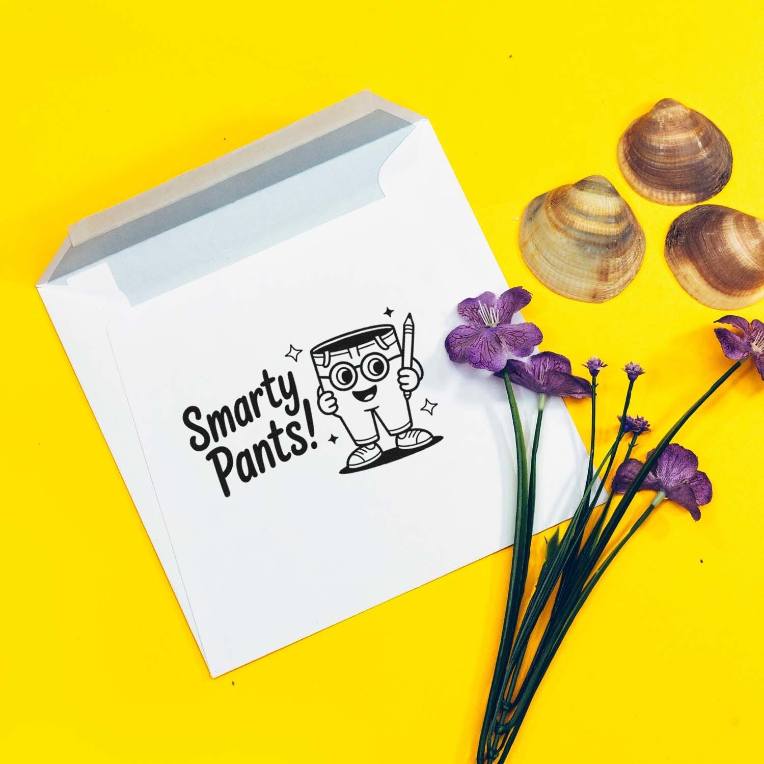 White mailer with black Smarty Pants stamp seal, bright yellow background, purple flowers, and seashells.