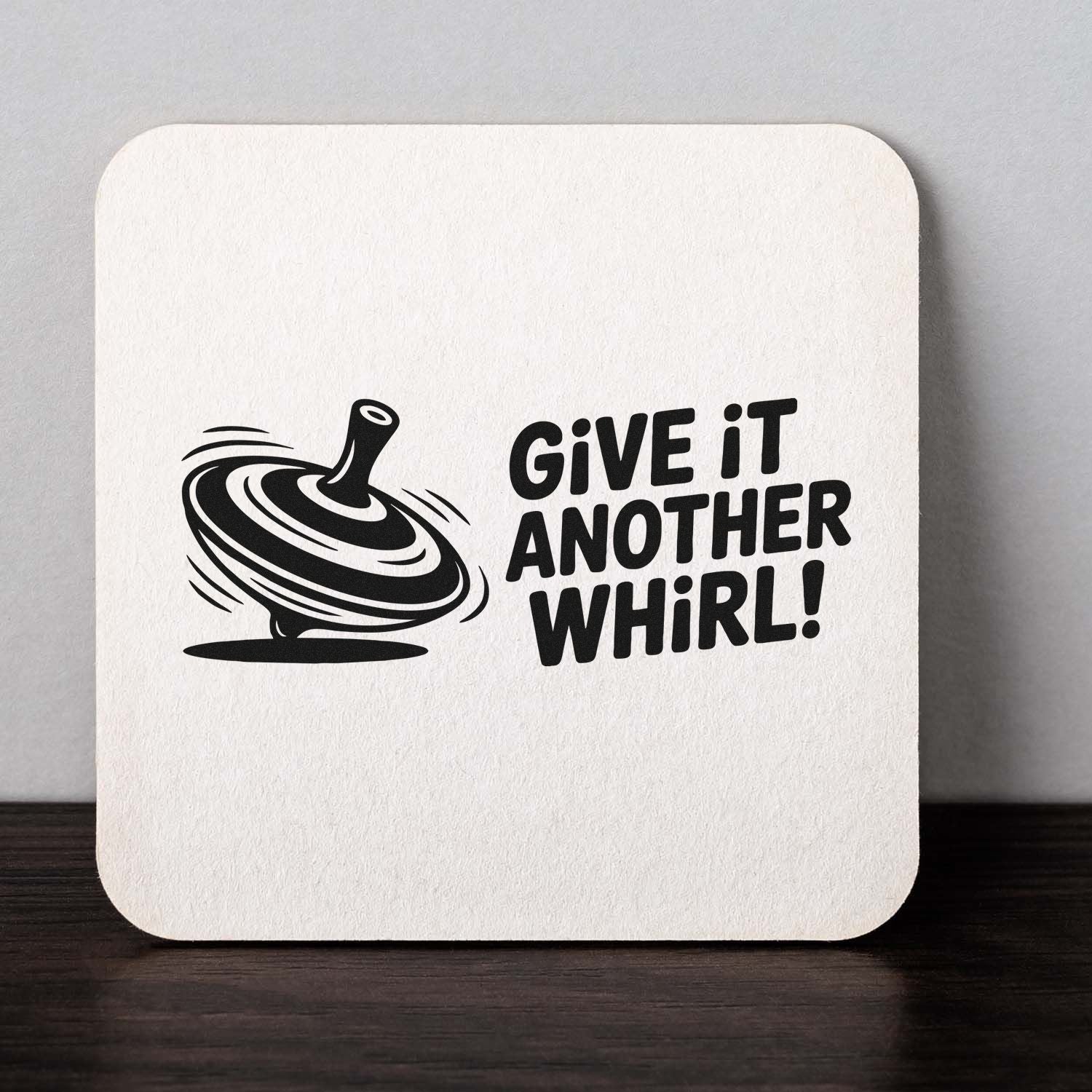 Black custom stamp and seal on white rounded card, featuring a spinning top and bold Give it another whirl! text.