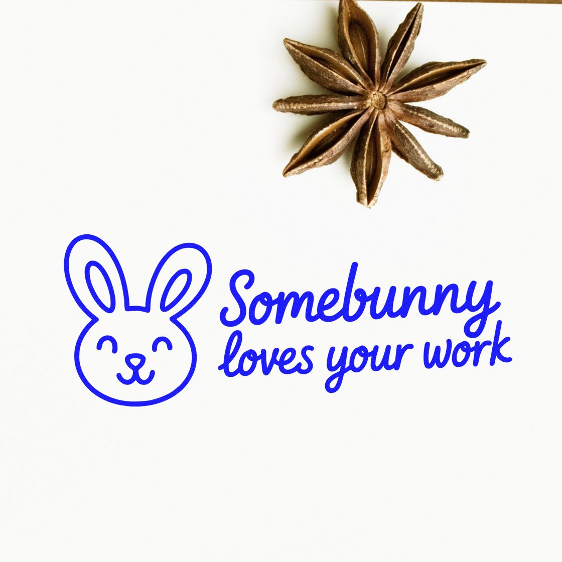 Blue bunny rubber stamp with Somebunny loves your work and brown star anise seal on white background.