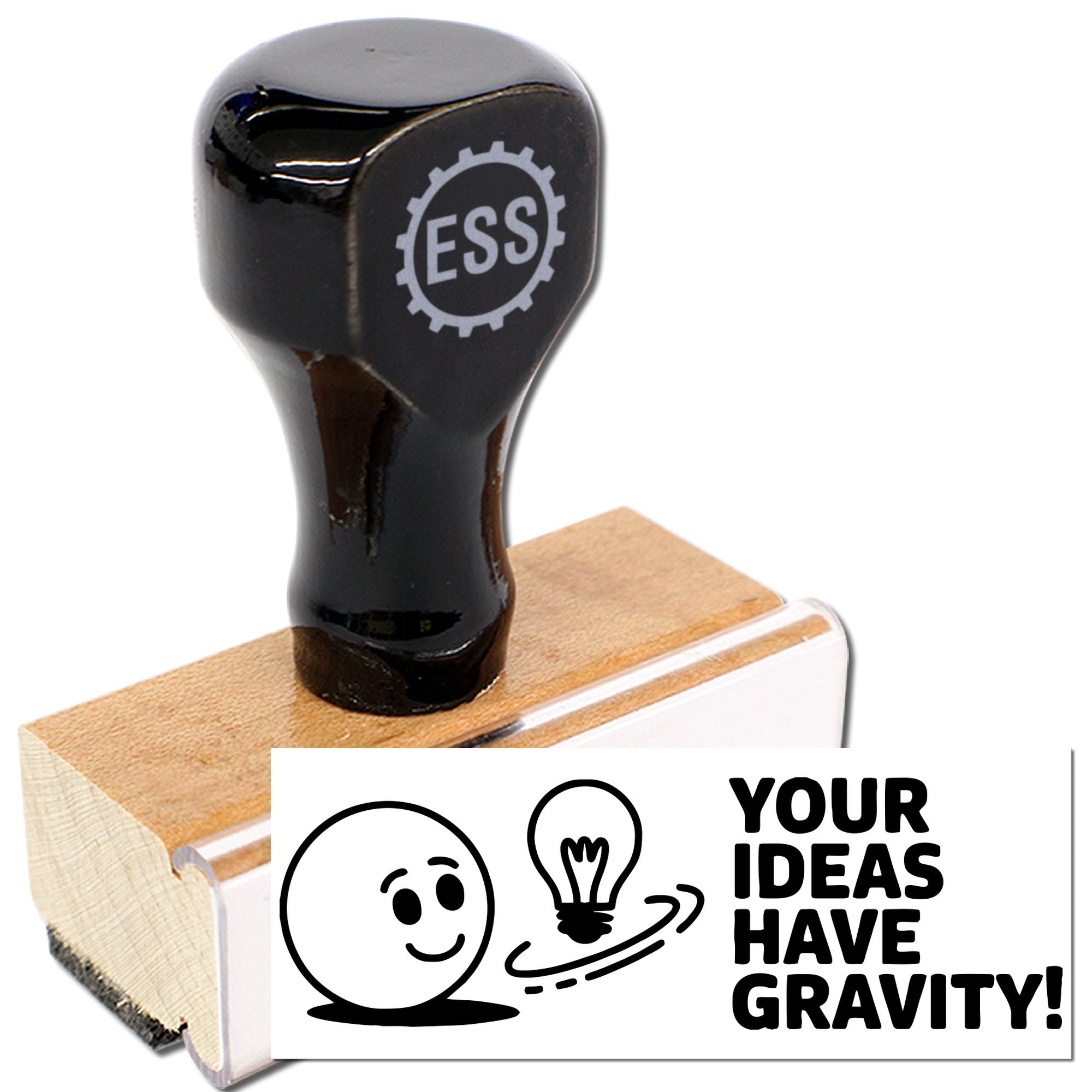 Black ESS rubber stamp on a wooden block with white custom seal artwork reading "Your Ideas Have Gravity!"