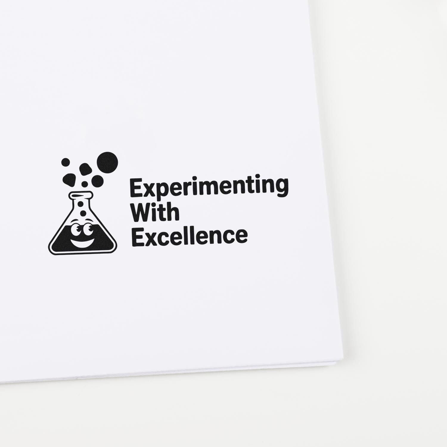 Black stamp seal with smiling lab flask and Experimenting With Excellence text on white paper.