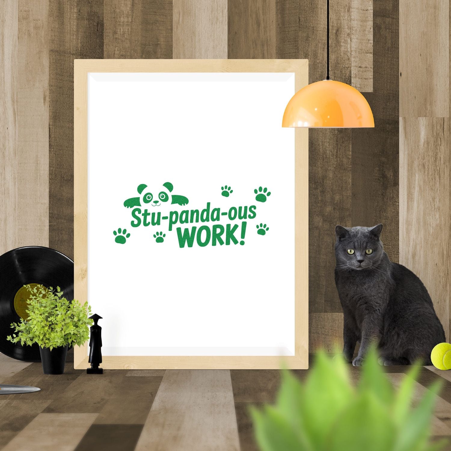 Green panda stamp and seal design reading Stu-panda-ous Work! on white board, with paw prints and a light wood frame.
