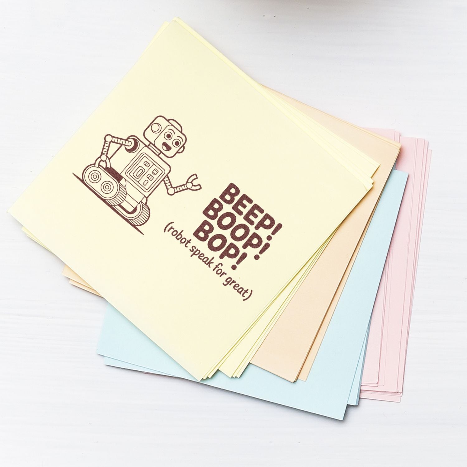 Pastel stamp and seal sheets with brown robot design and BEEP! BOOP! BOOP! text on cream, blue, pink, and beige paper.